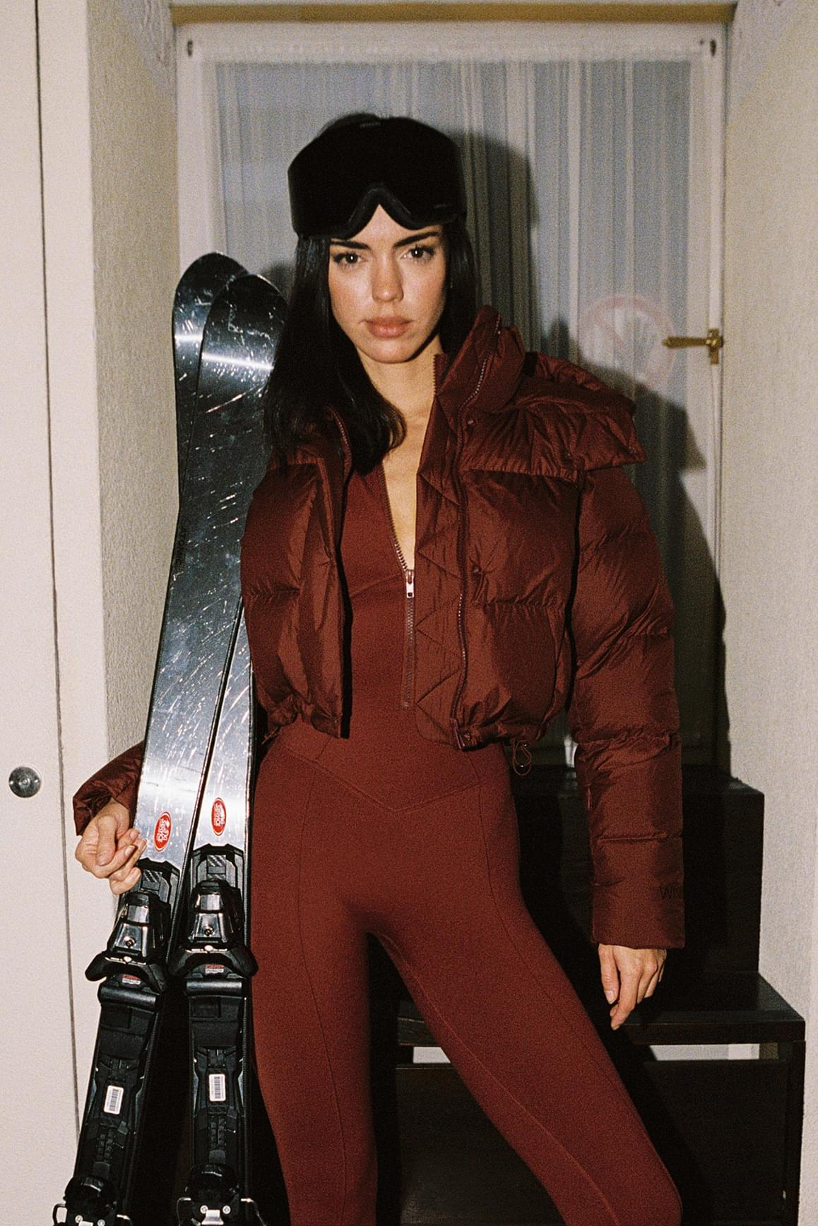 WISKII Cropped Convert Down Jacket in black, showing its hood, quilted design, and lightweight, insulated construction.