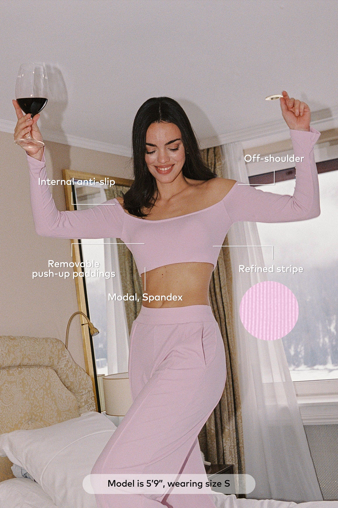 WISKII Verve off-shoulder crop top in black, stylish shirt with long sleeves and fitted design, shown on a model.