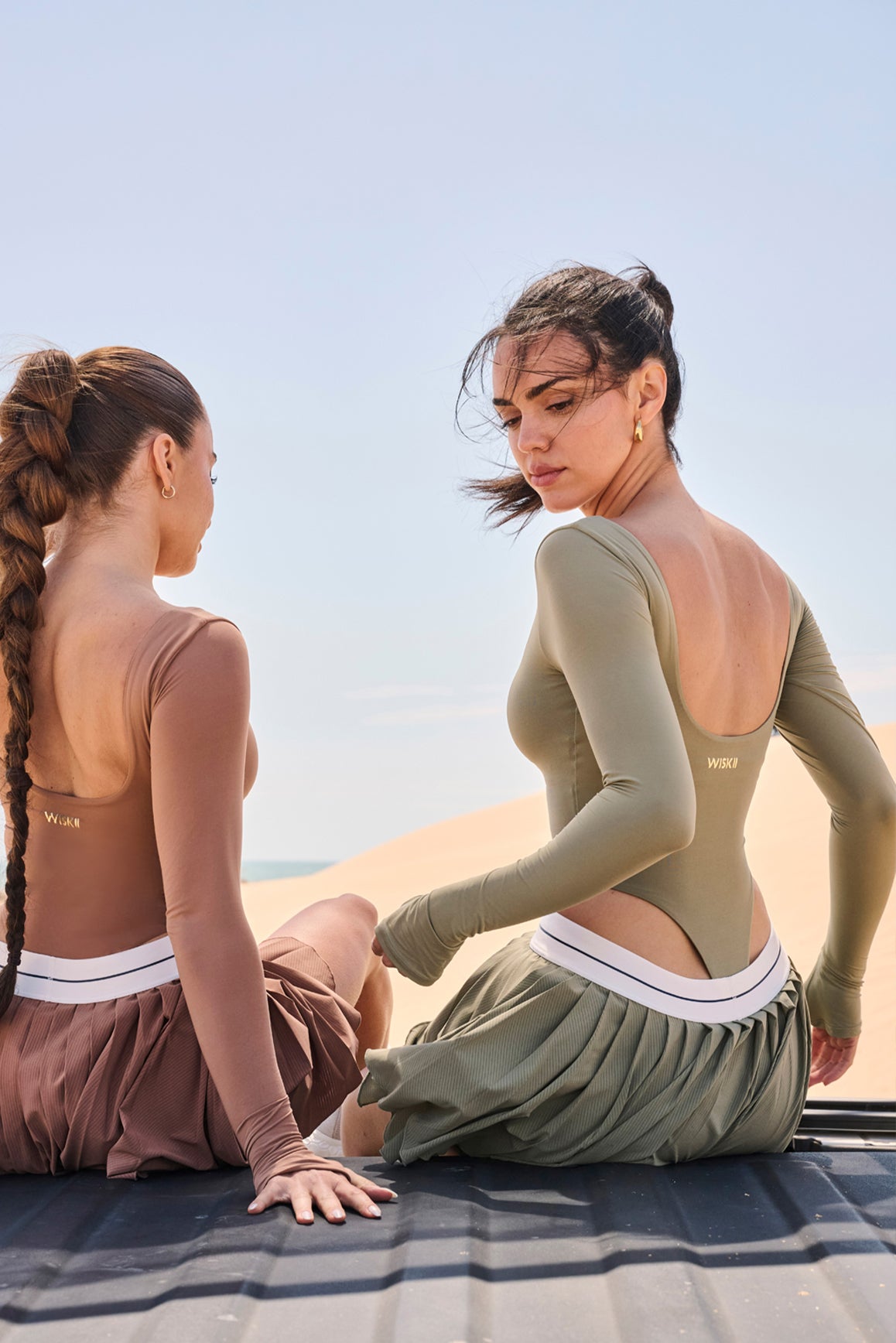 WISKII scoop neck long sleeve bodysuit in muted khaki, fitted design with seamless long sleeves and scoop neckline.