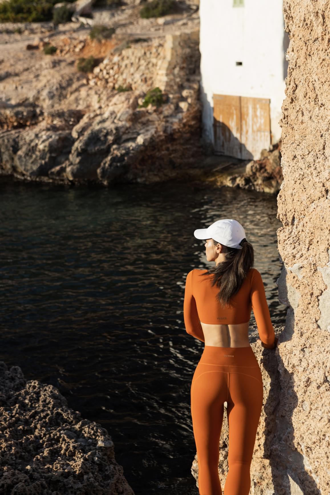 WISKII twist-front long sleeve crop top in vibrant firecracker design, featuring a stylish twist front and fitted long sleeves.