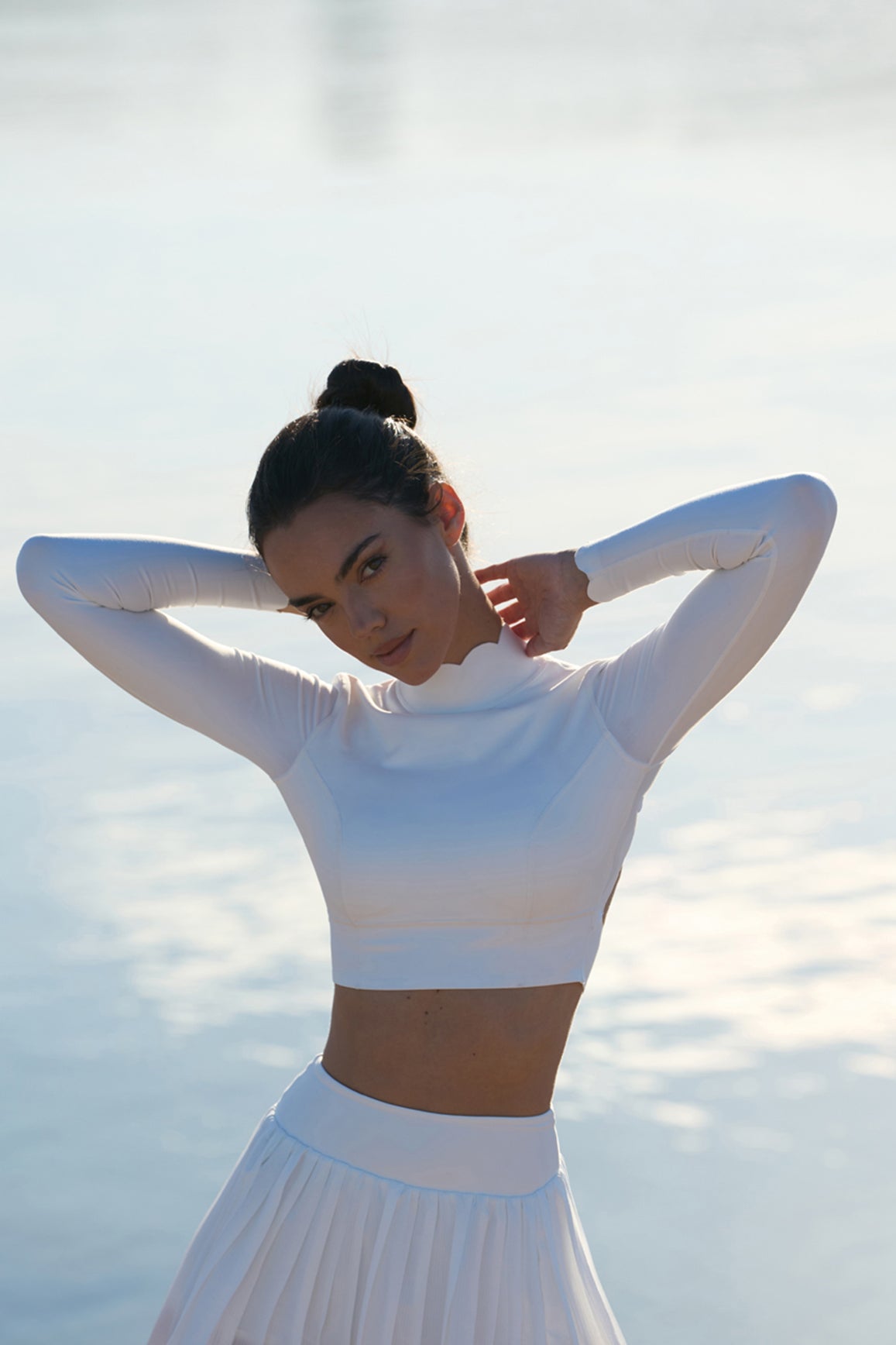 Ivory open back long sleeve crop top by WISKII, featuring a stylish crop top design with an open back and long sleeves.