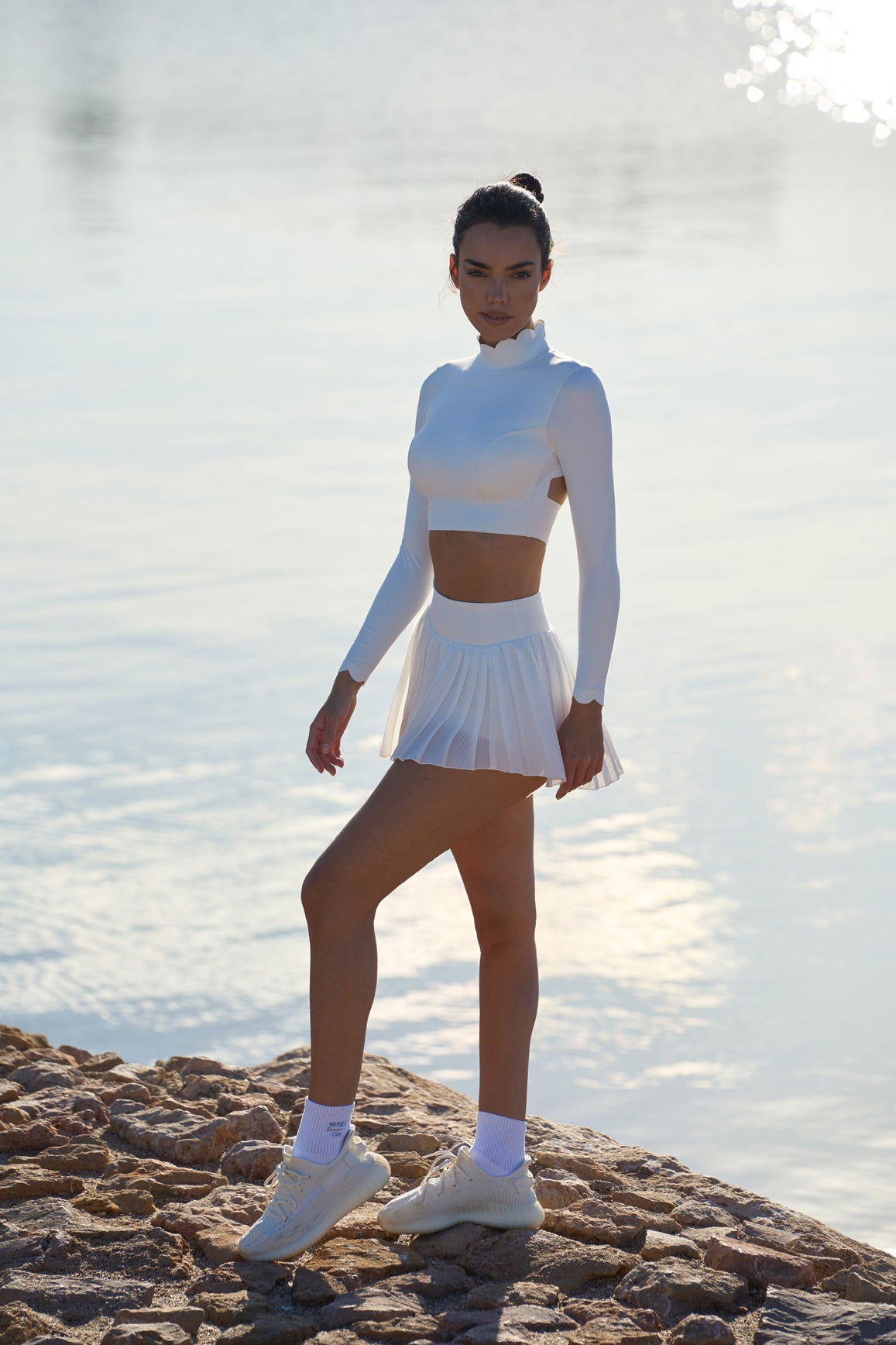 Ivory open-back long sleeve crop top by WISKII, stylish crop top with a fitted design and open-back detail.