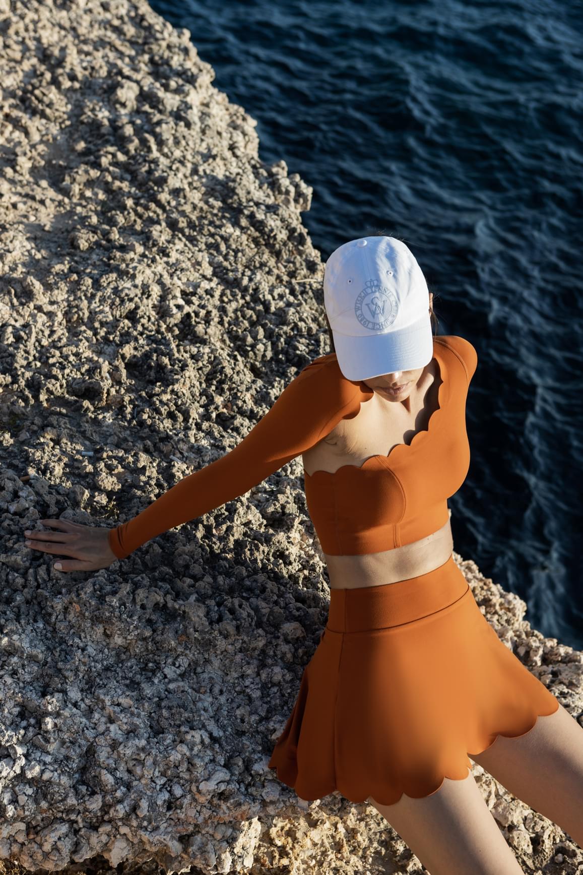 WISKII asymmetrical long sleeve crop top with sakura zen design, featuring a stylish, modern fit and unique neckline.