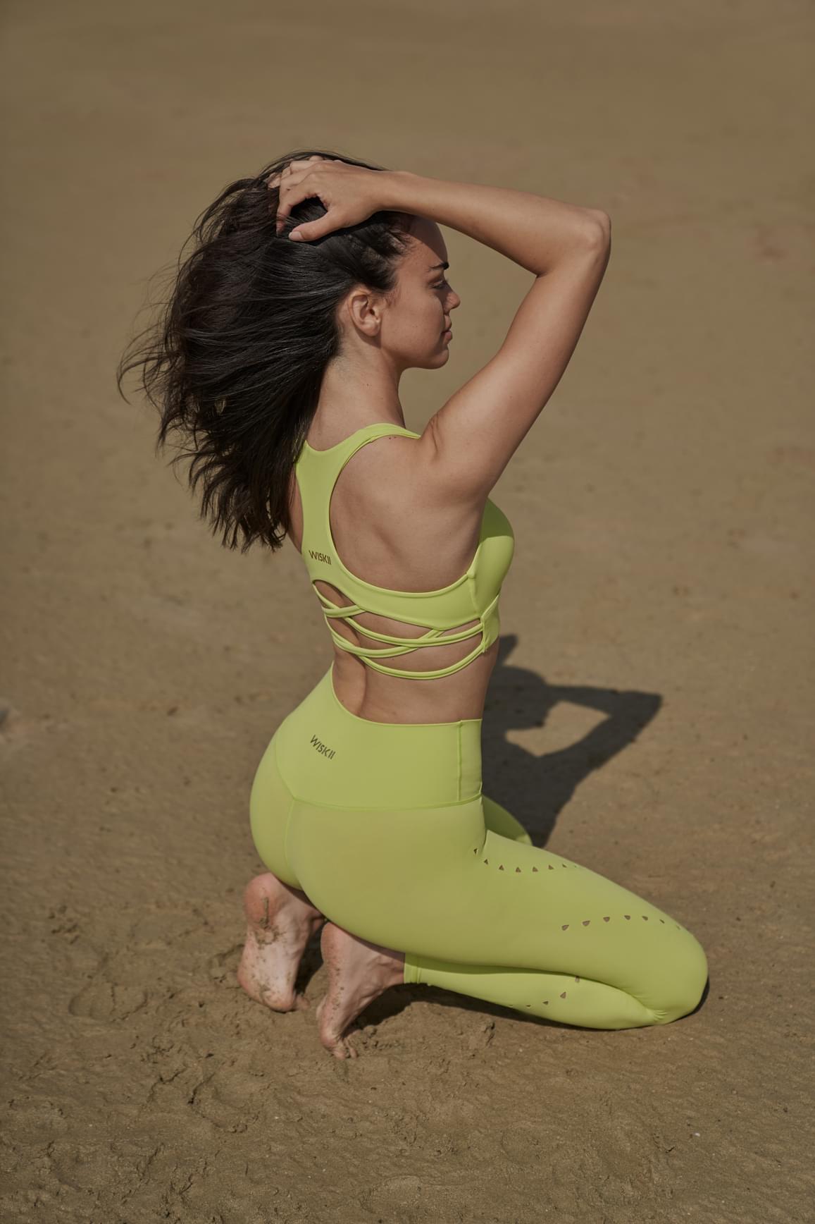 Ivory V-waist laser cut sports leggings by WISKII, close-up of sleek design and intricate laser cut details.