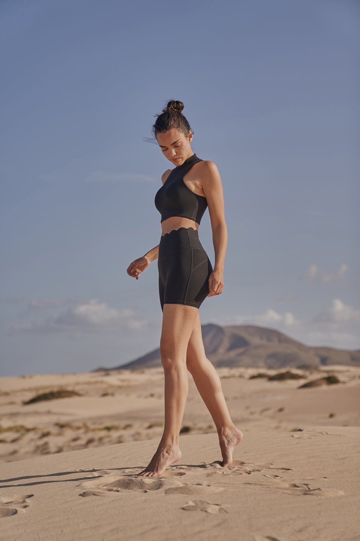 Black WISKII high-waist sculpting biker shorts showing a close-up of the fitted, stretchy fabric and high-rise waist design.