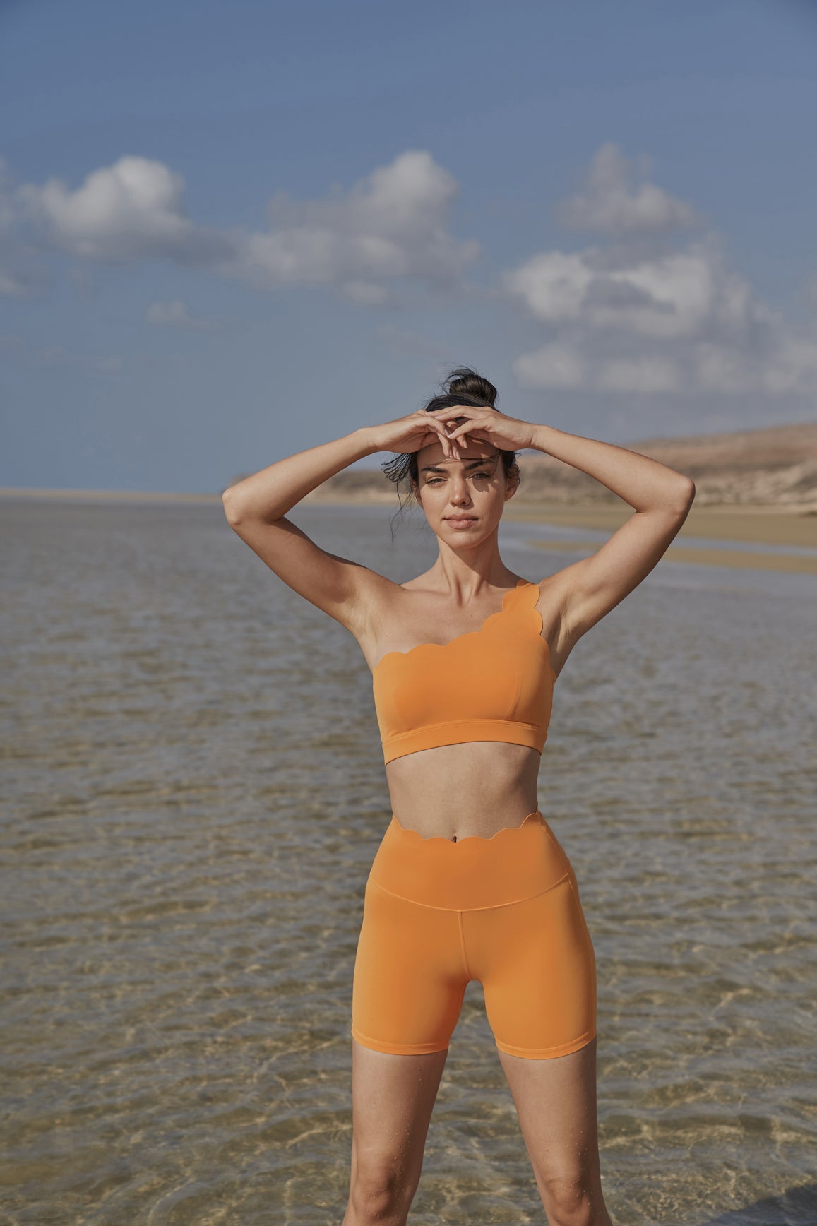 WISKII high-waist sculpting biker shorts in flame orange, designed for a snug fit and active wear comfort