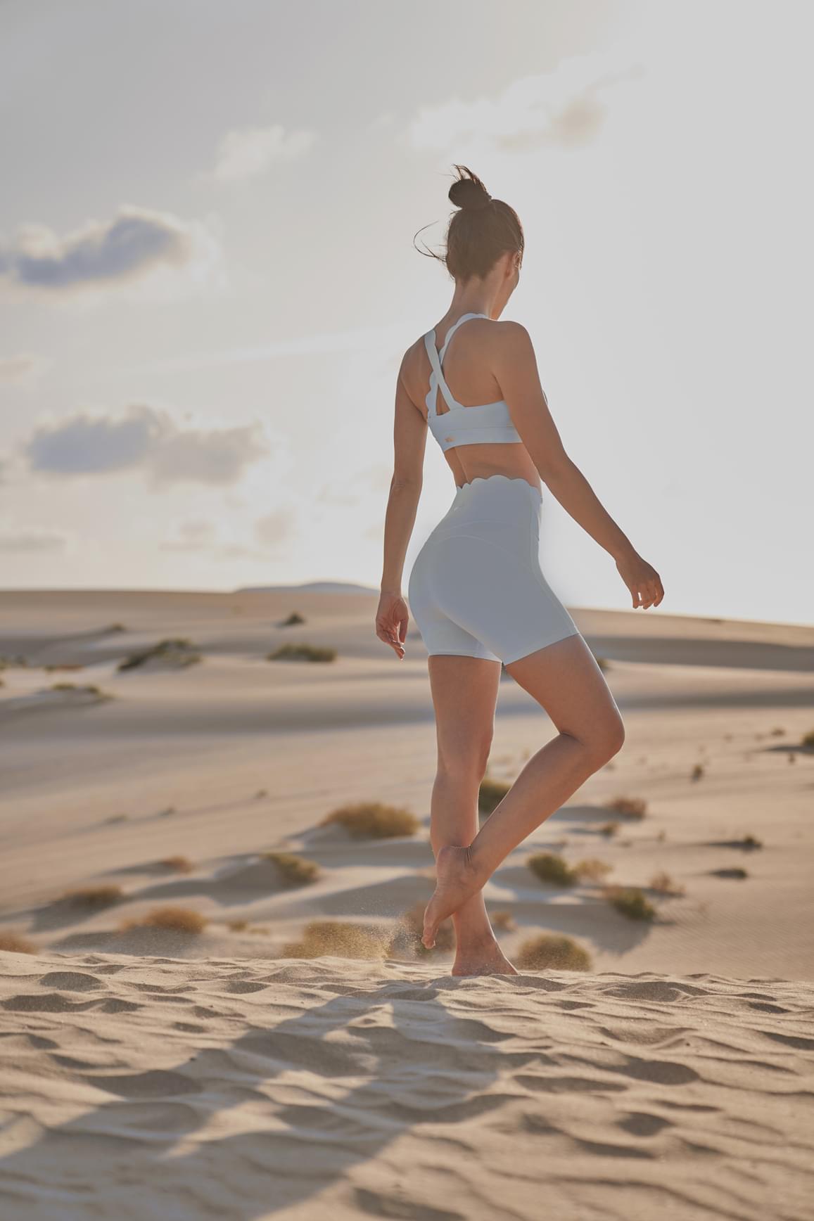 Ivory high-waist sculpting biker shorts by WISKII, showcasing a close-up of the fitted, stretchy workout shorts on a plain background.