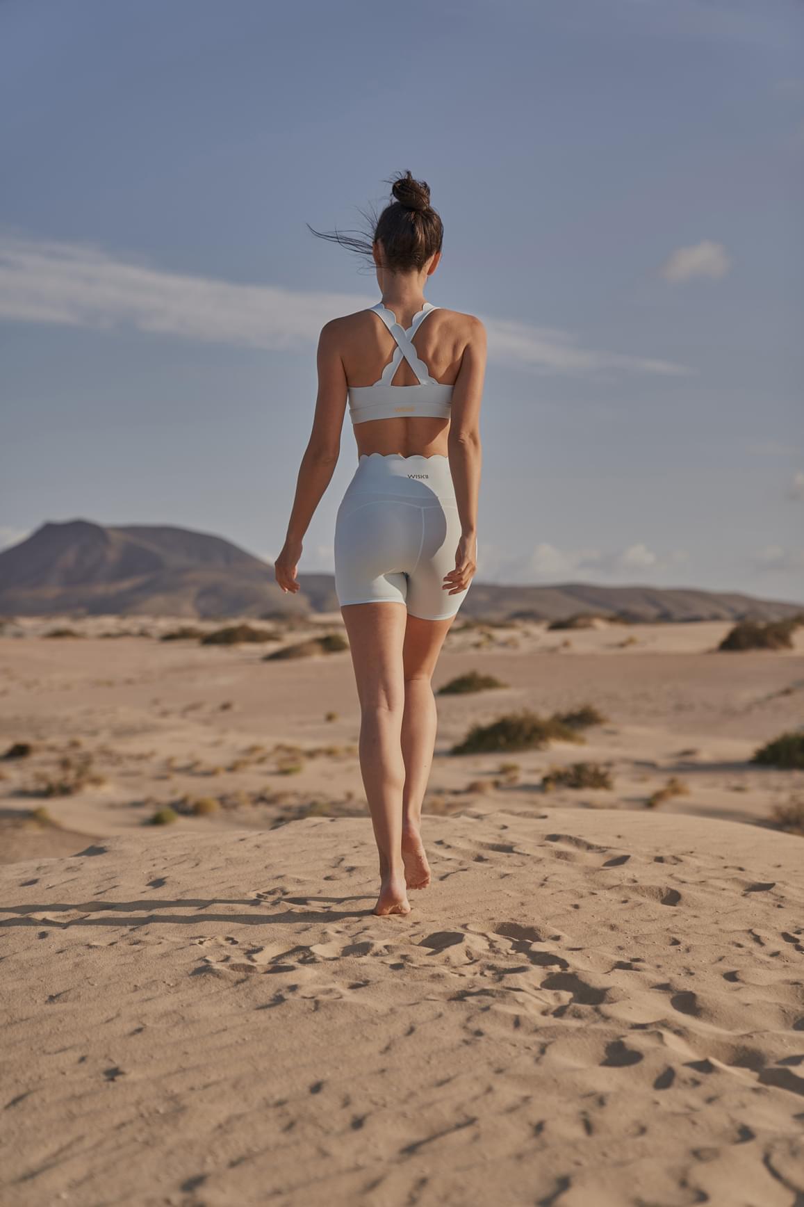 Ivory high-waist sculpting biker shorts by WISKII, showing a close-up of the fitted, stretchy shorts designed for comfort and style.