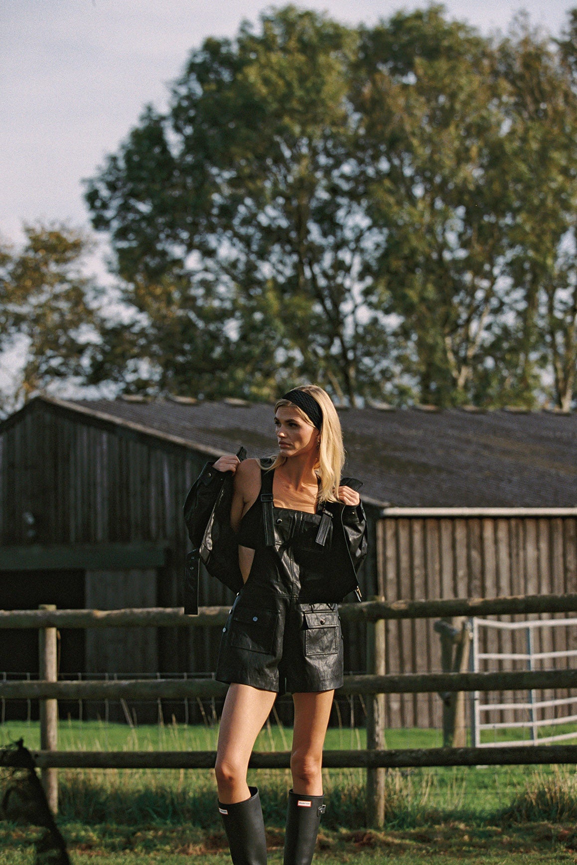 WISKII faux leather overall shorts in taupe, featuring a high waist and adjustable straps, shown on a model.