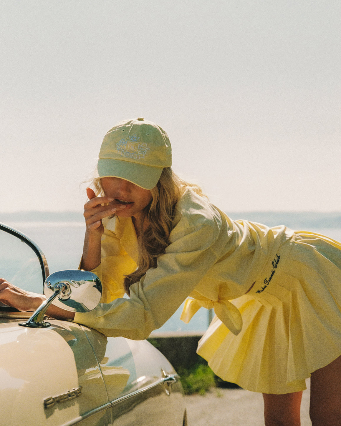 WISKII Riviera relaxed cotton shirt, lightweight and casual, shown in a bright summer outdoor setting.