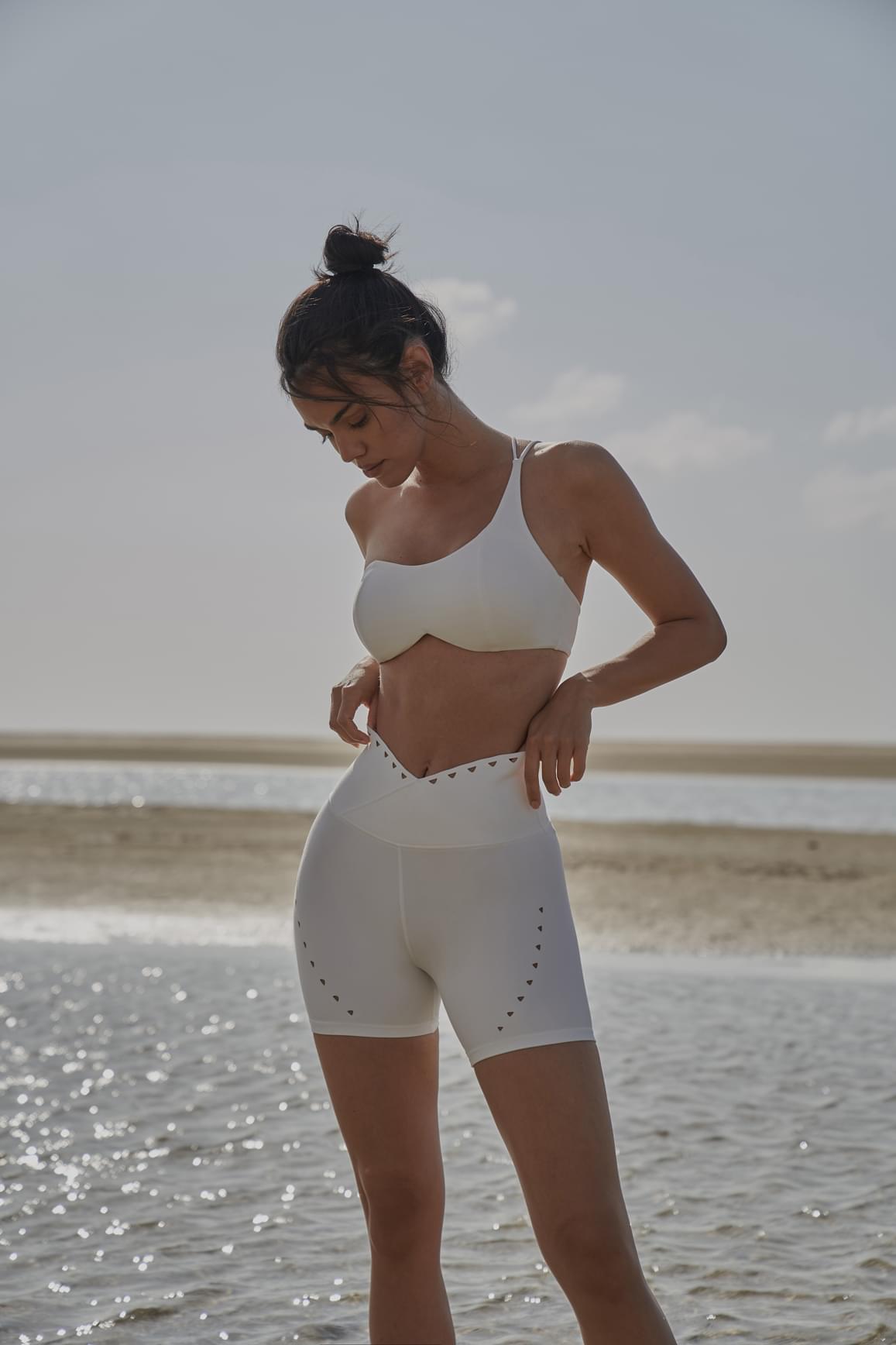 Black WISKII sports bra with one shoulder contour design, featuring supportive and stylish athletic wear for active comfort.