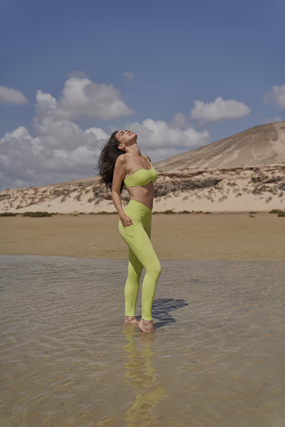 Black WISKII sports bra with a stylish one-shoulder design and contour fit, ideal for active wear and support.
