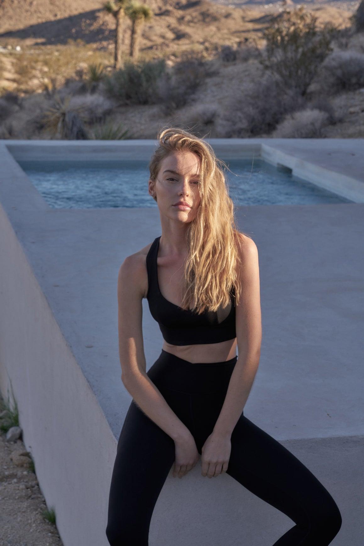 WISKII Sweetheart Bra Tank in black, featuring a fitted sports bra design with a sweetheart neckline and adjustable straps.