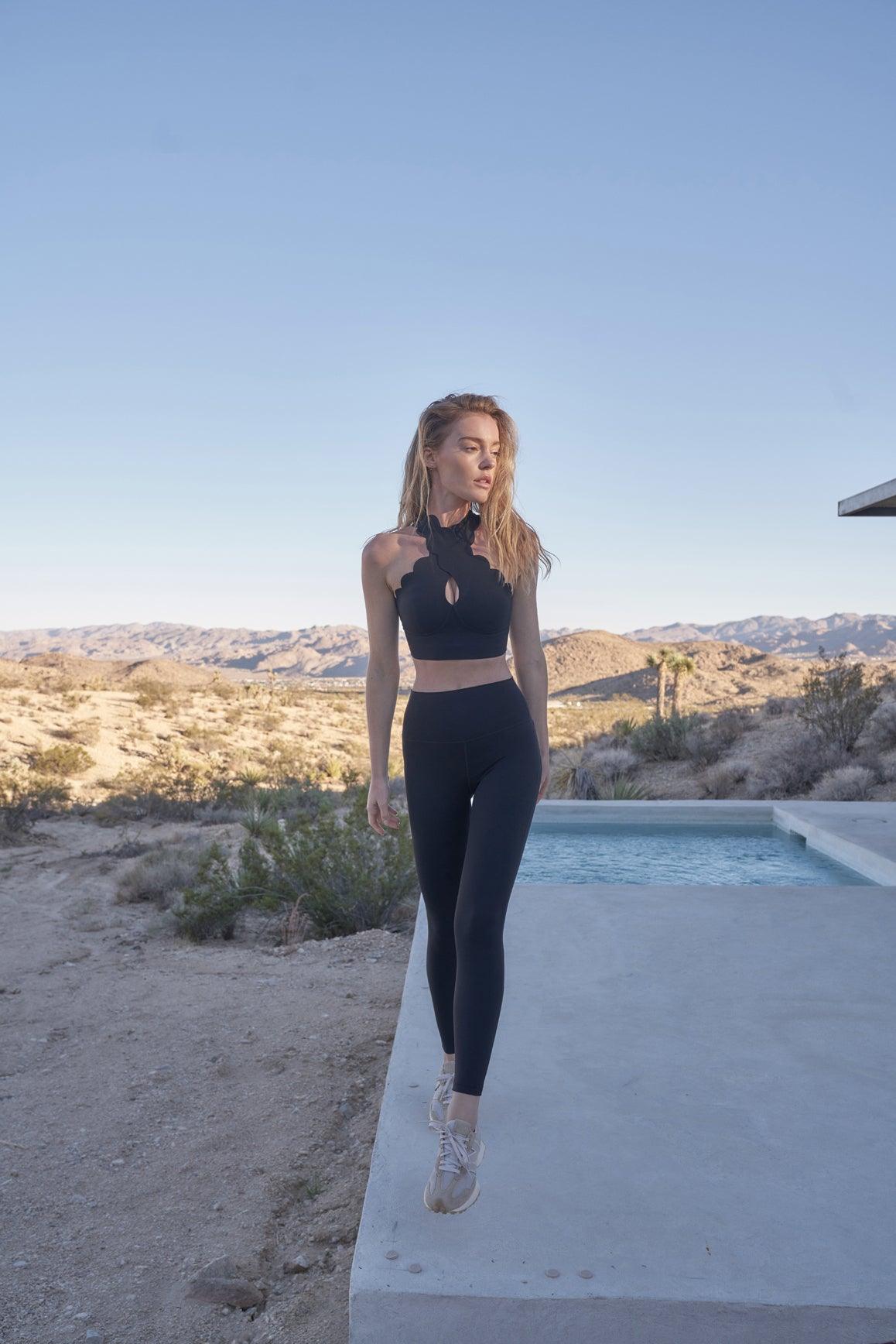 Black WISKII Crisscross Sports Bra with stylish front cross design, made for comfortable activewear.