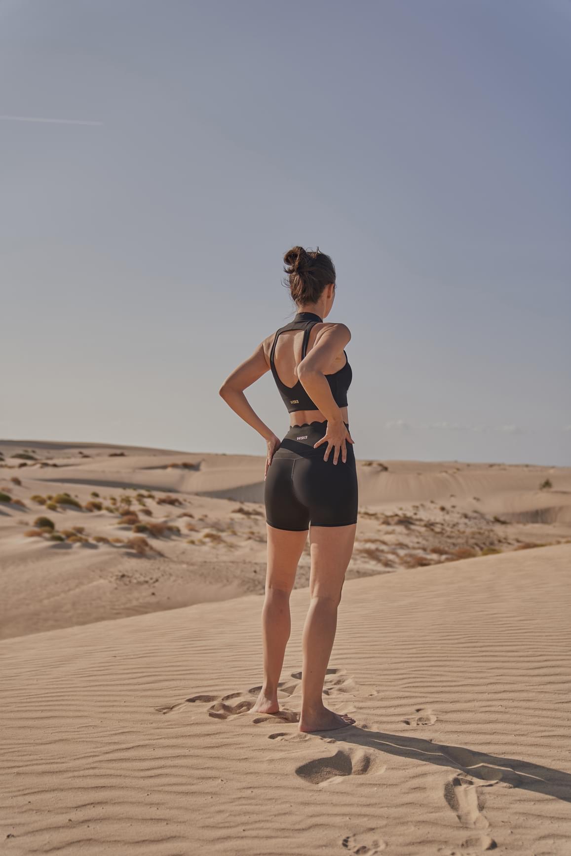 WISKII ivory sports bra with diamond cutout design, mock neck style, and supportive fit for active wear.