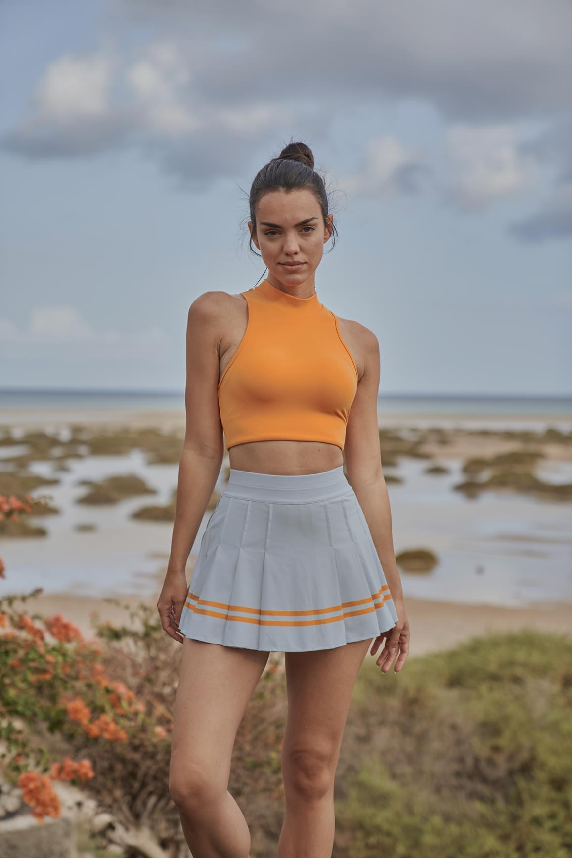 Ivory WISKII sports bra with diamond cutout mock neck design, featuring a supportive fit and stylish athletic wear.