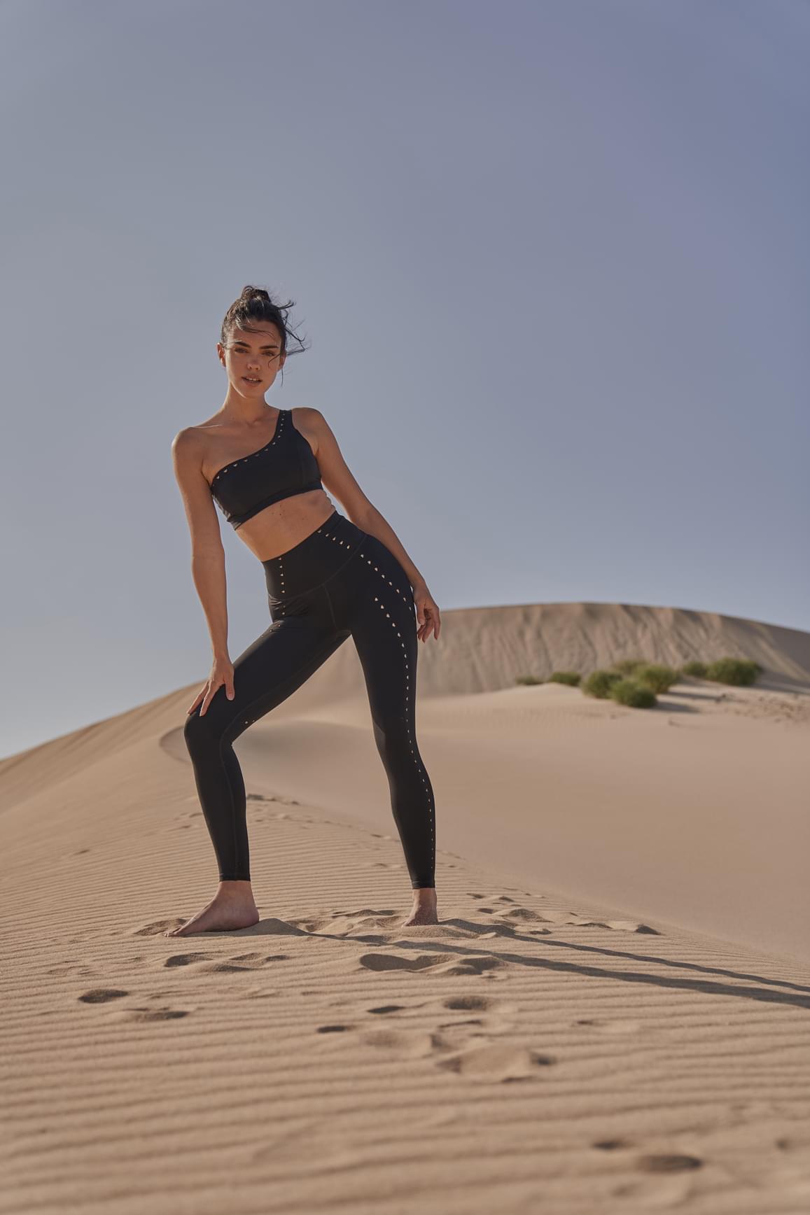 Ivory WISKII one-shoulder laser cut sports bra showing sleek design and breathable fabric for active wear.