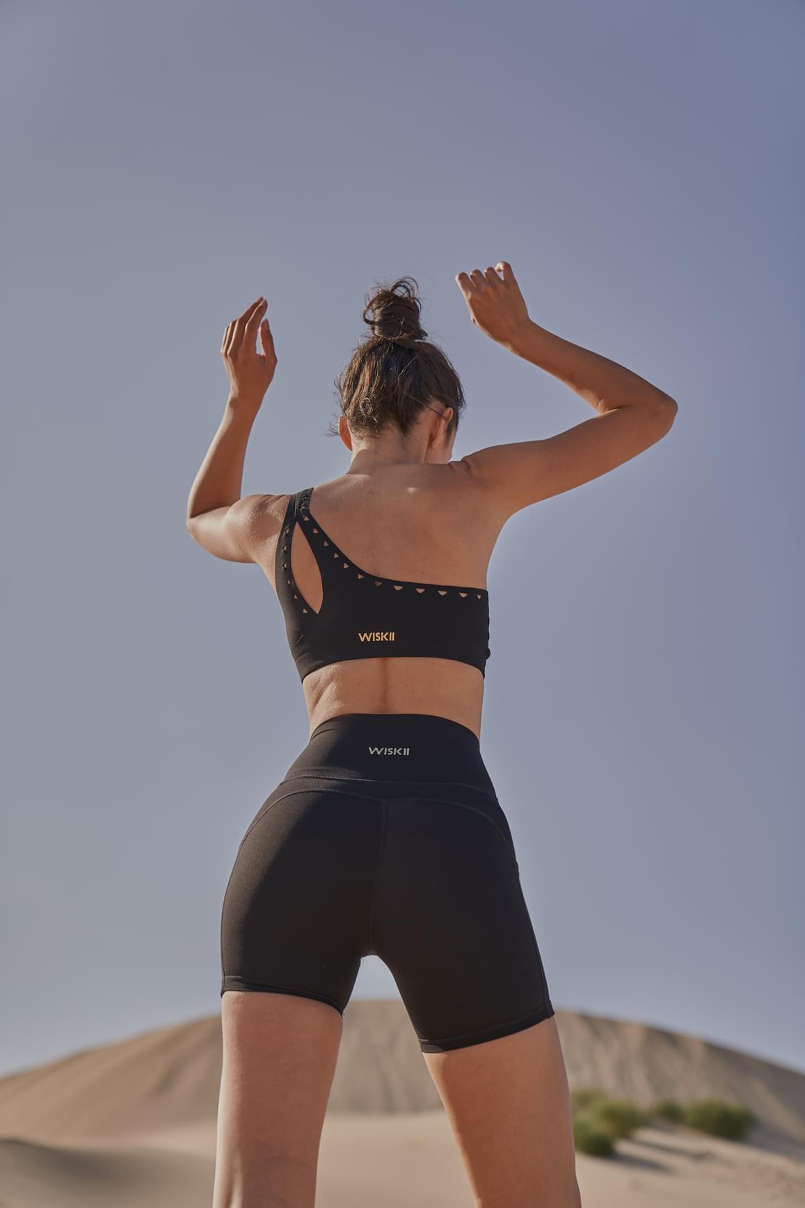Ivory WISKII one-shoulder laser cut sports bra with stylish design and breathable fabric, perfect for active wear.