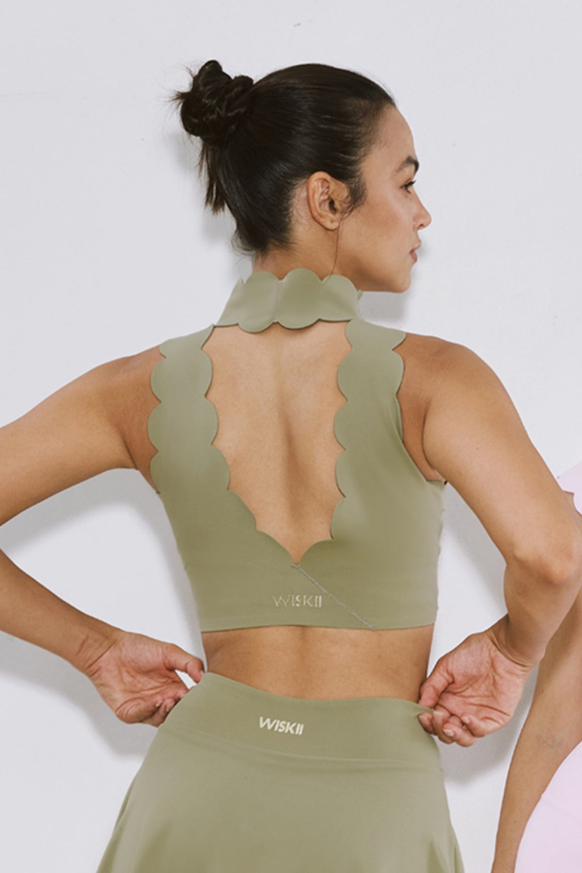 WISKII high neck scallop V-back sports bra in muted khaki, featuring a supportive fit and stylish design.