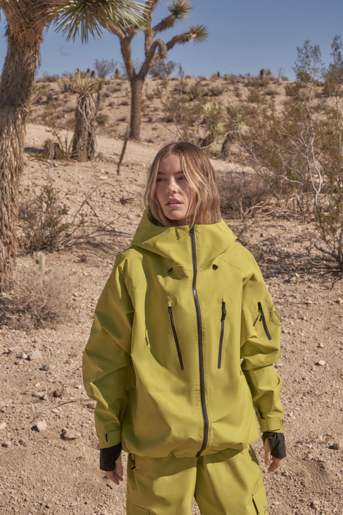 WISKII 3L waterproof hardshell performance jacket with hood, designed for outdoor activities, shown in a compact, lightweight style.