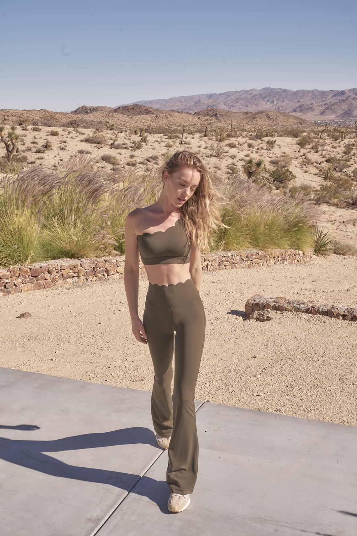 Ivory high-waist flare leggings by WISKII, showcasing the fitted waist and flared leg design on a model.