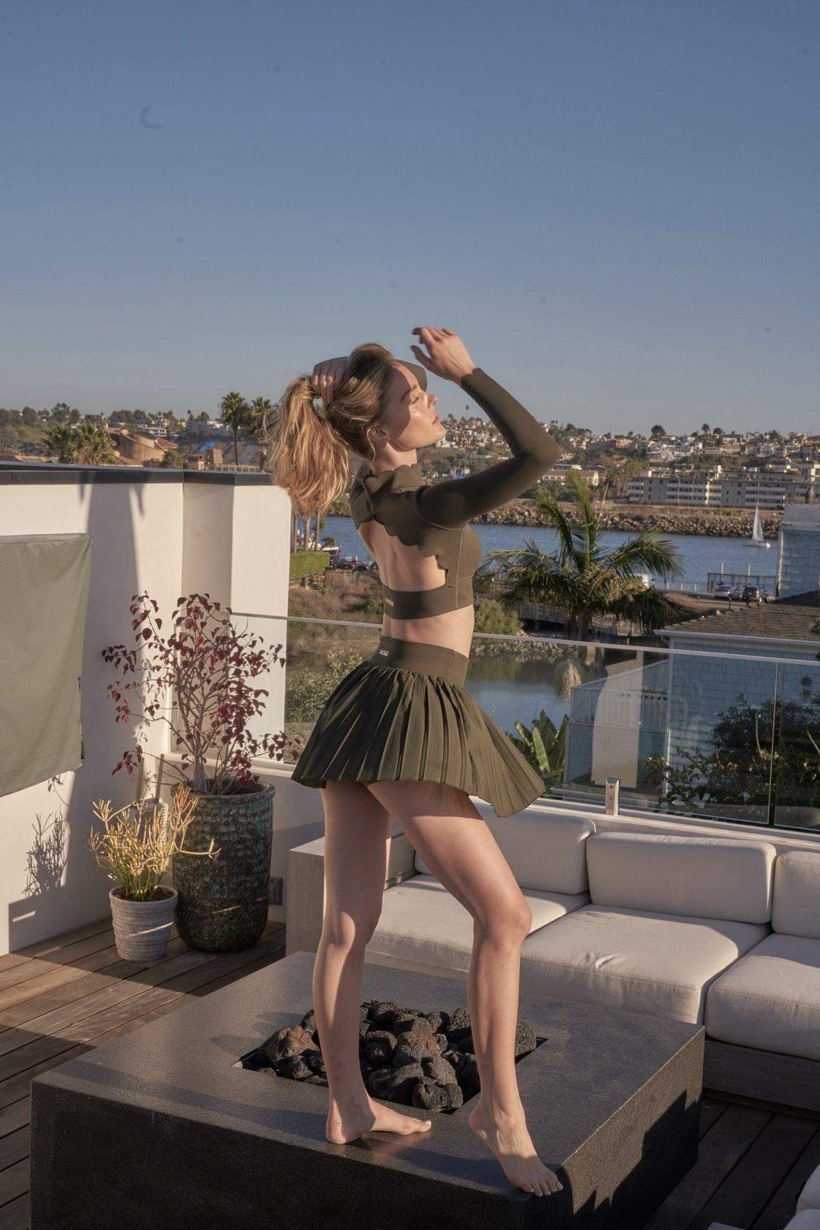 Ivory WISKII pleated skirt with a flowy, elegant design, shown laid flat with pleats and smooth fabric details.