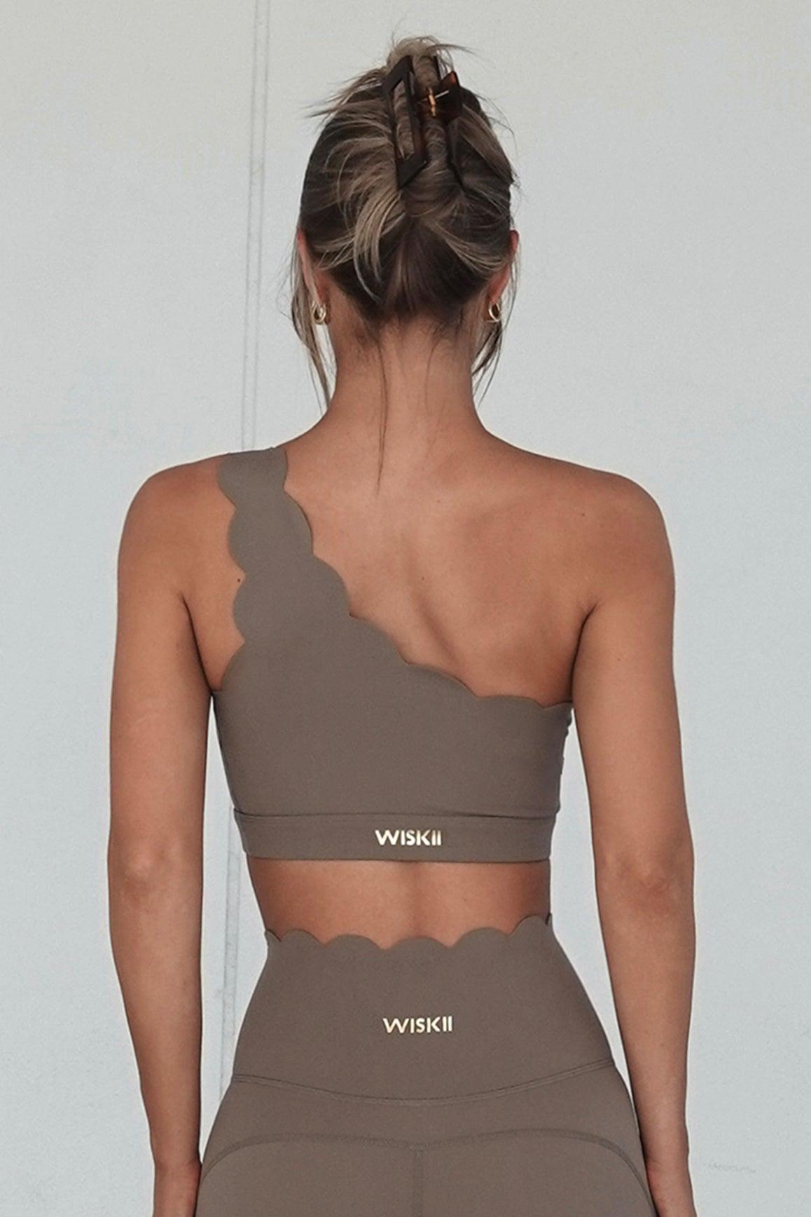 WISKII dynamic one-shoulder sports bra in mulled wine color, featuring a sleek design and supportive fit for active wear.