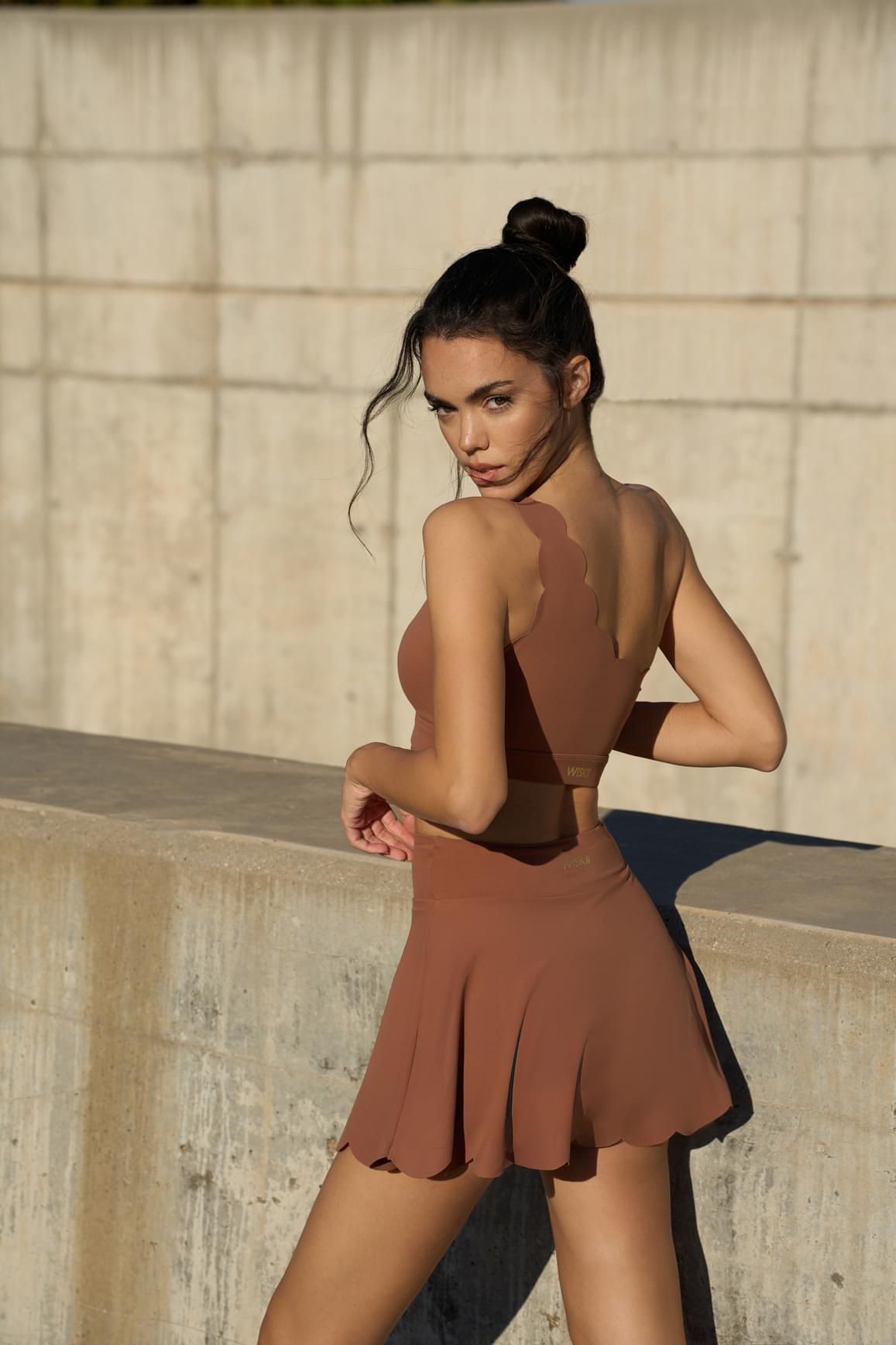 WISKII Dynamic One Shoulder Sports Bra in mulled wine color, featuring a stylish single-shoulder design for active wear.