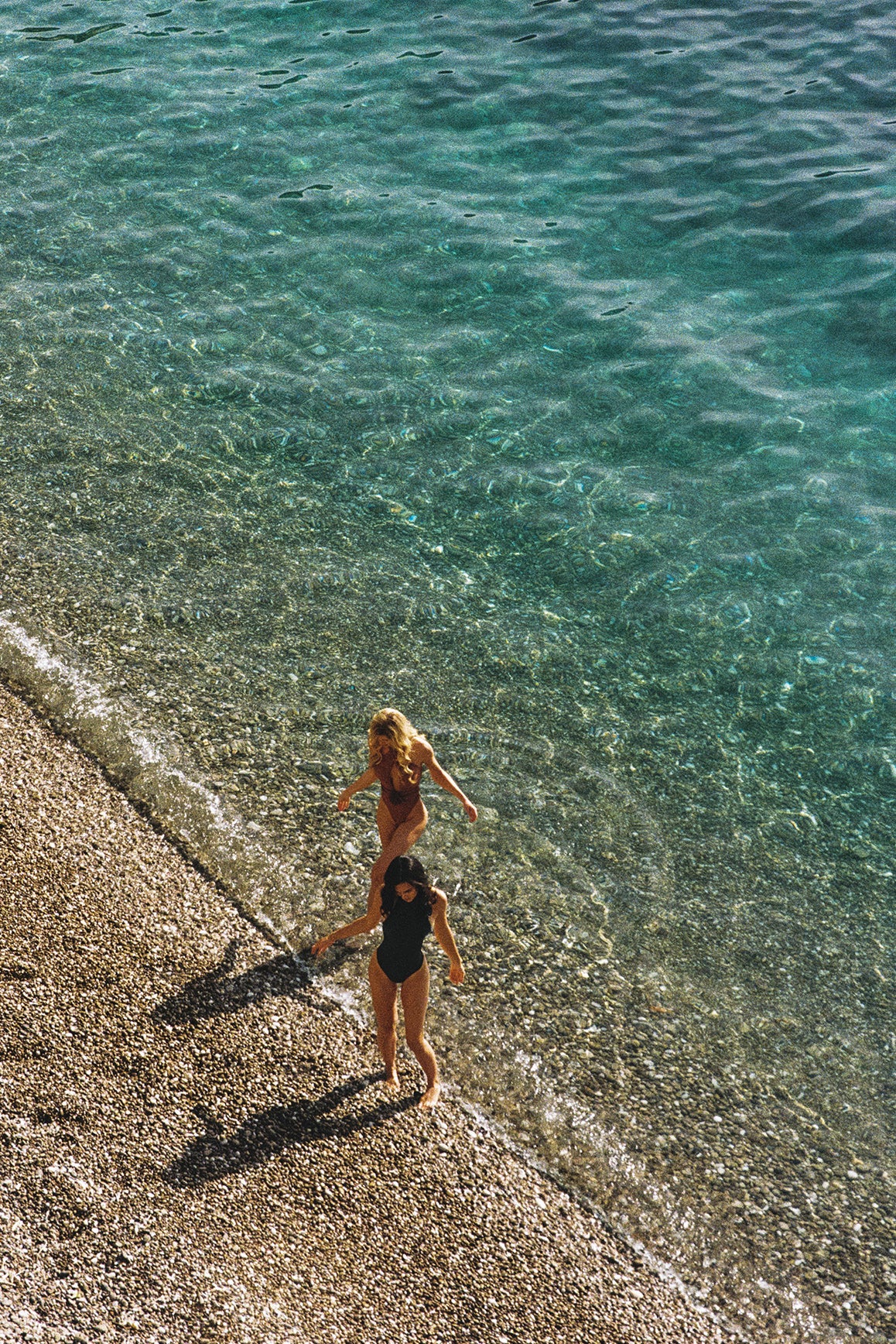 Model wears Riviera Floral Crisscross One-Piece Swimsuit | Color Black | WISKII Active
