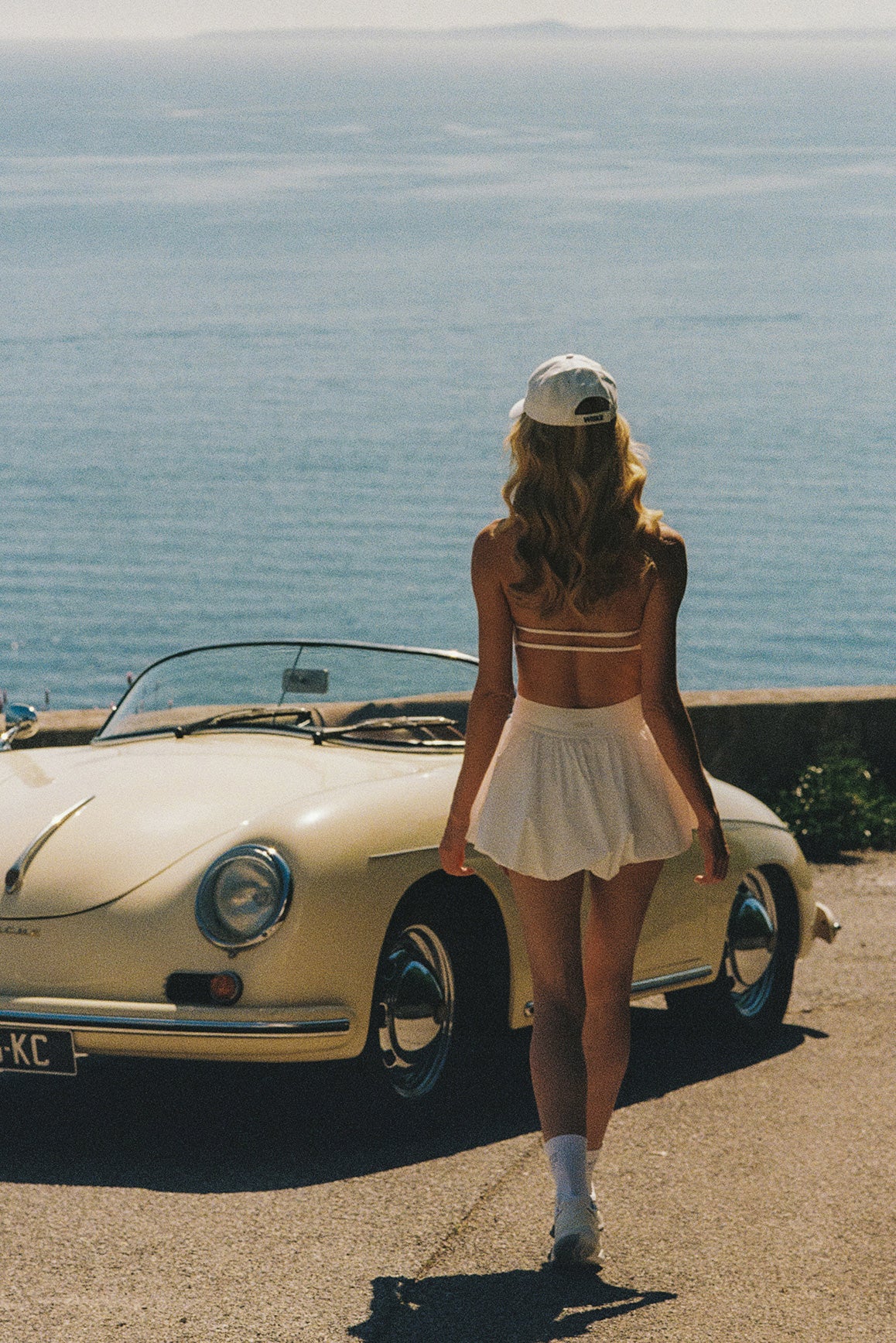 Model wears Riviera Floral Halter Mock Neck Top and Mini Bubble Skirt | Ivory | WISKII Active