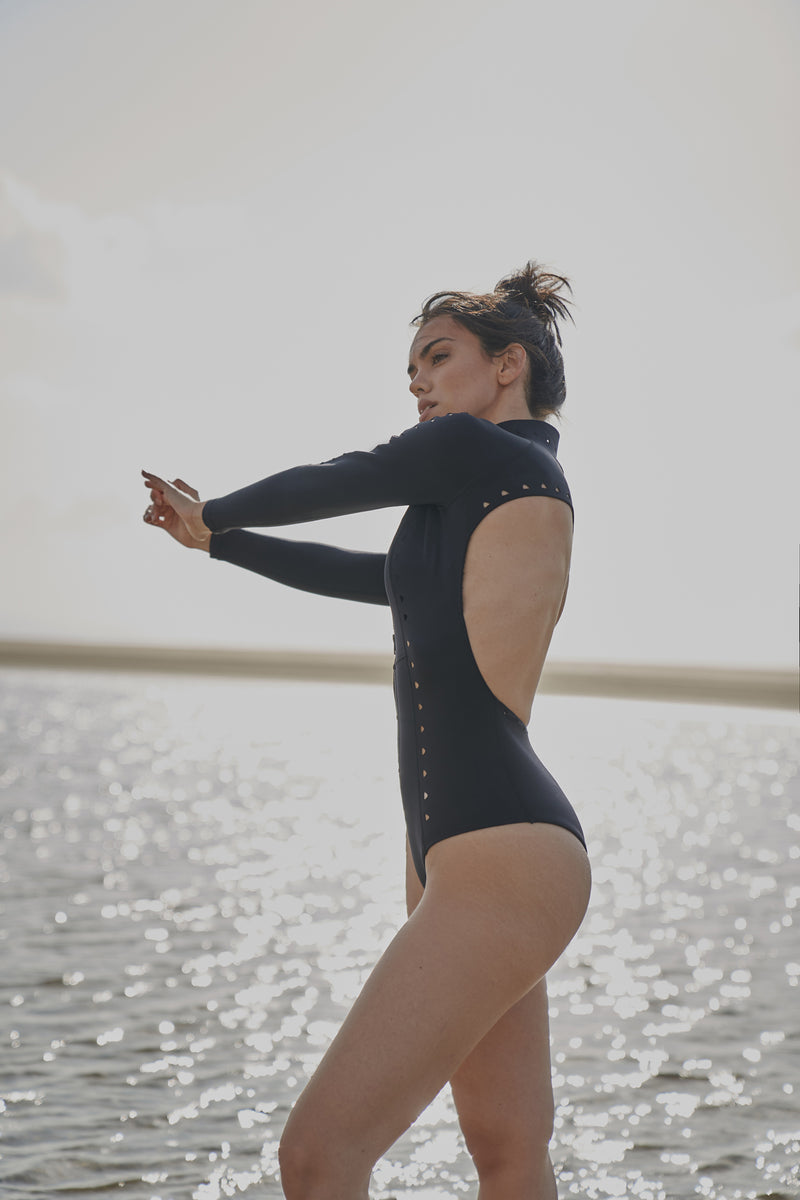 Model wears WISKII Long Sleeve Open Back Laser Cut Surfsuit