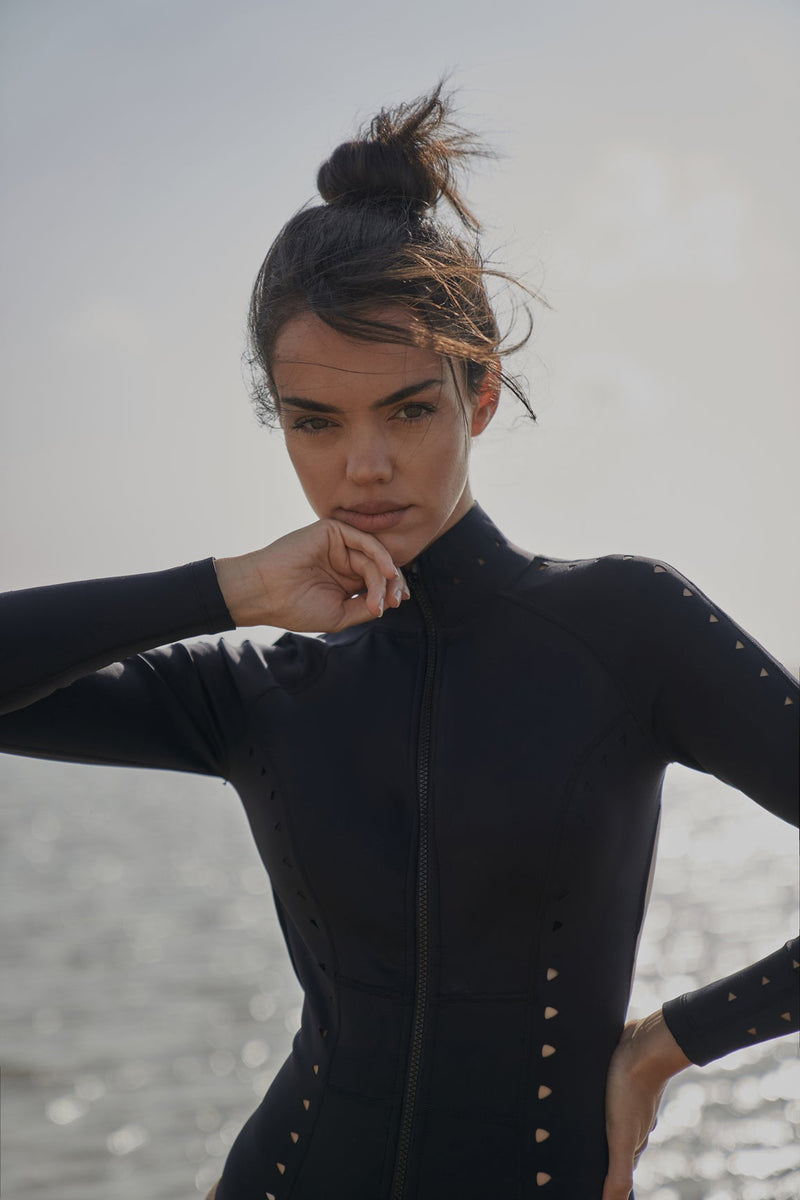 Model wears WISKII Long Sleeve Open Back Laser Cut Surfsuit