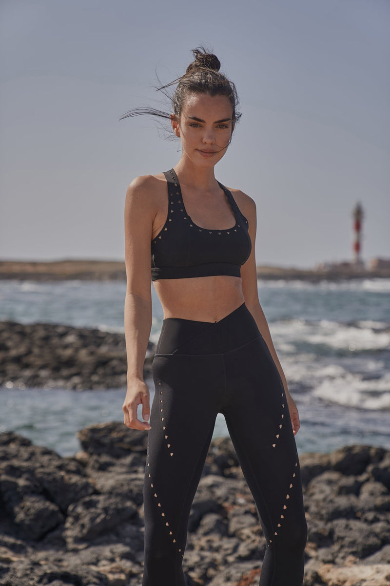 Model wears Racerback Laser Cut Sports Bra + V-waist Laser Cut Sports Legging | WISKII 