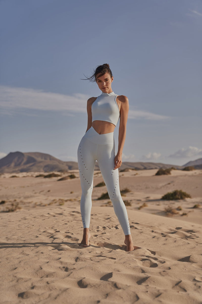 Model wears Diamond Cutout Mock Neck Bra + V-waist Laser Cut Sports Legging | WISKII
