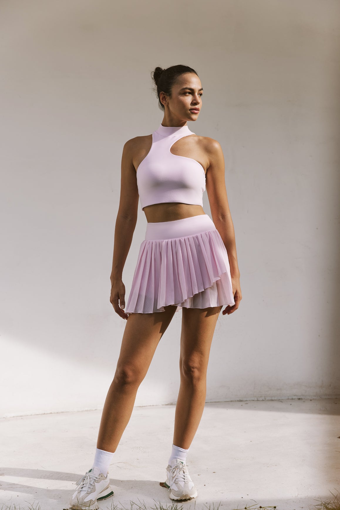 Model wears WISKII Pleated Skirts | WISKII ACTIVE