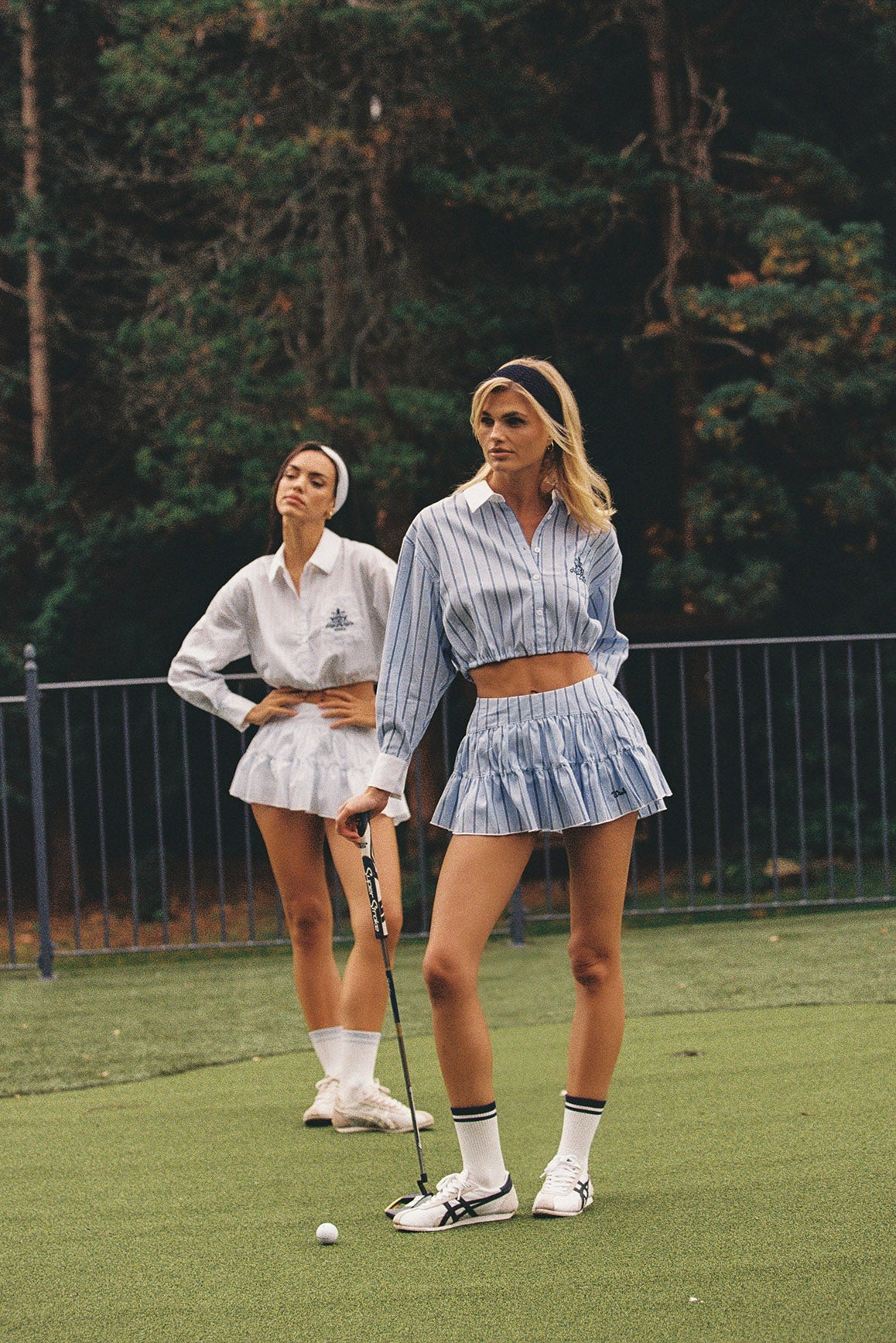 WISKII Stripe low-waist pleat skirt with vertical stripes and flowing fabric, styled for casual or formal wear.