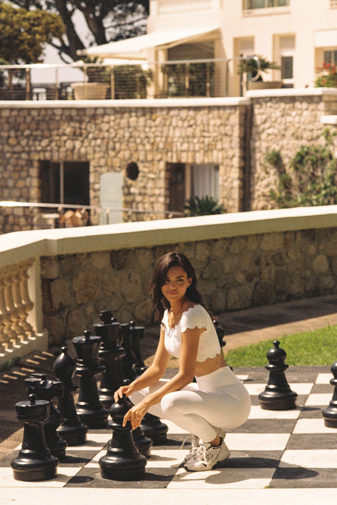 Model wears a Riviera Scallop Off Shoulder Sports Bra | Ivory | WISKII Active