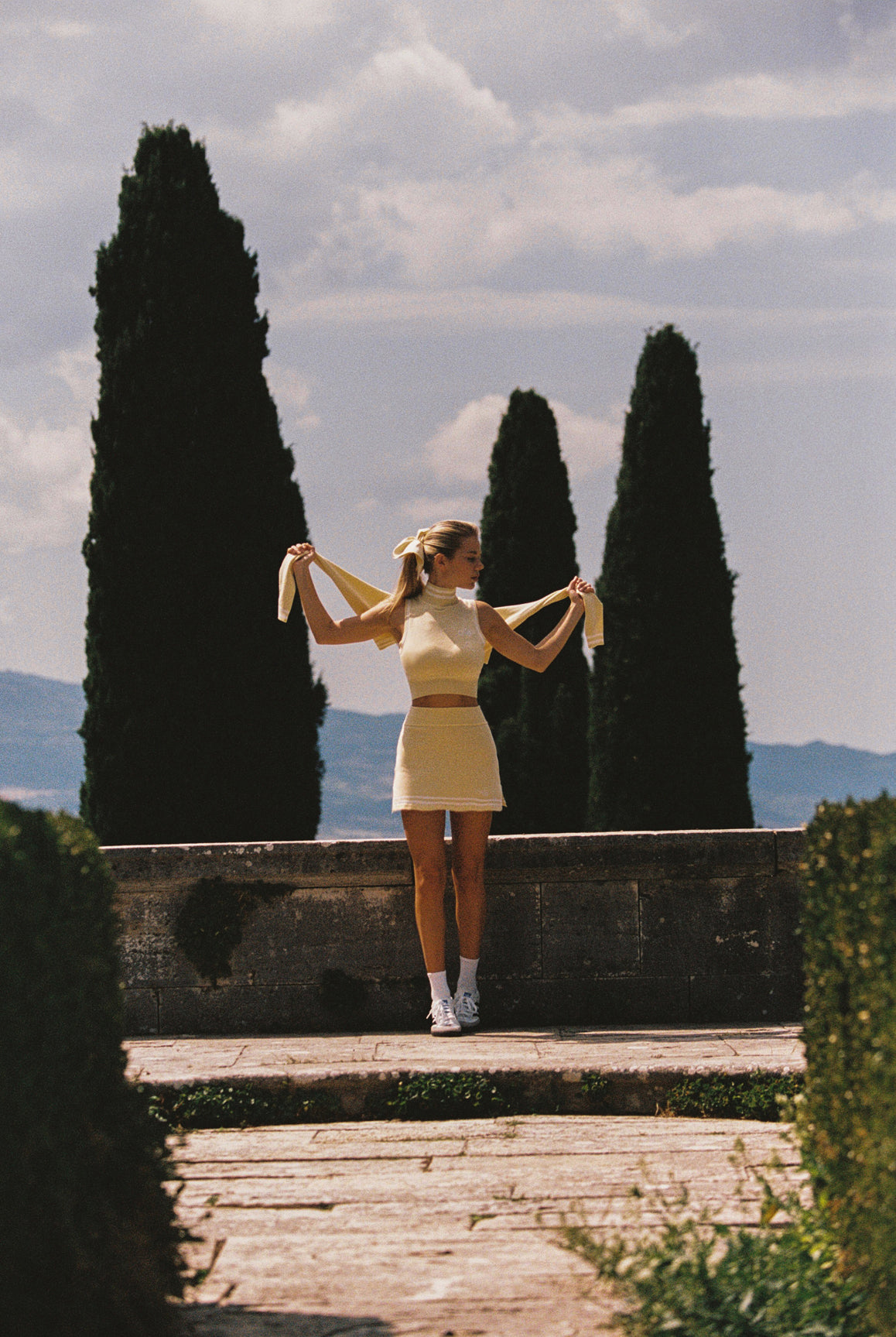 WISKII Mirto Knit Mock Neck Crop Top in lemon chiffon, featuring a stylish mock neck and sleeveless design.