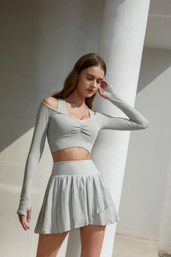 model wears a WISKII Pleated Skirts , color dawn, sport skirt