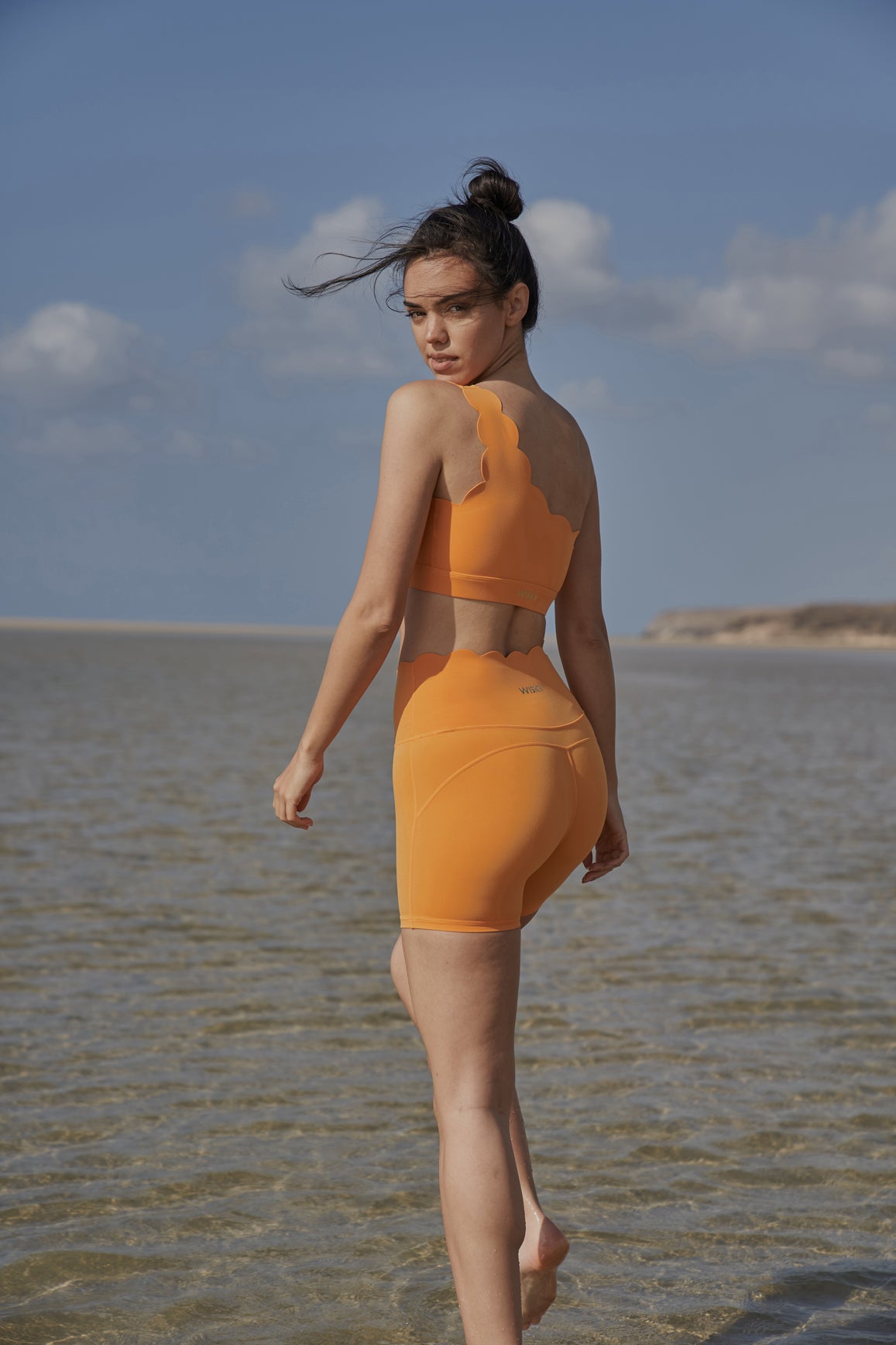 Model wears High-Waist Sculpting Biker Short|WISKII |Flameorange