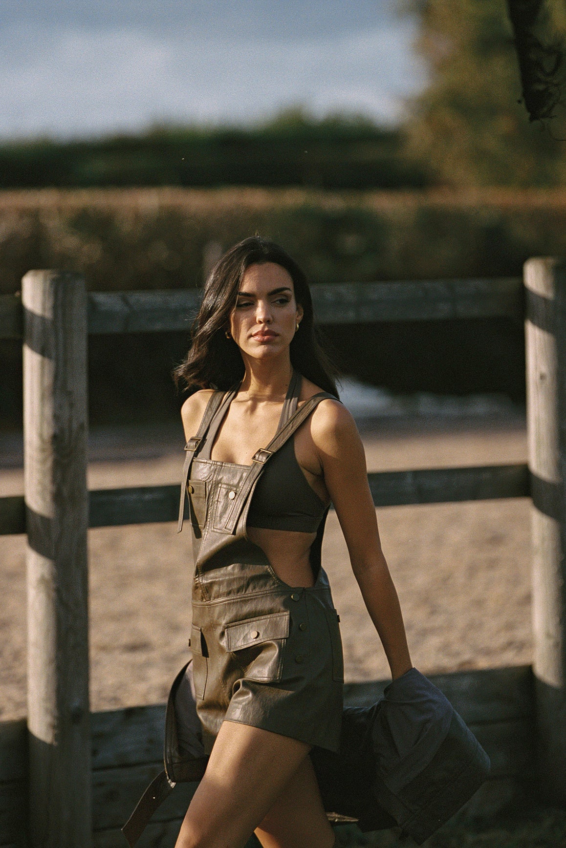 WISKII faux leather overall shorts in taupe color, featuring a stylish design with adjustable straps and front pockets.