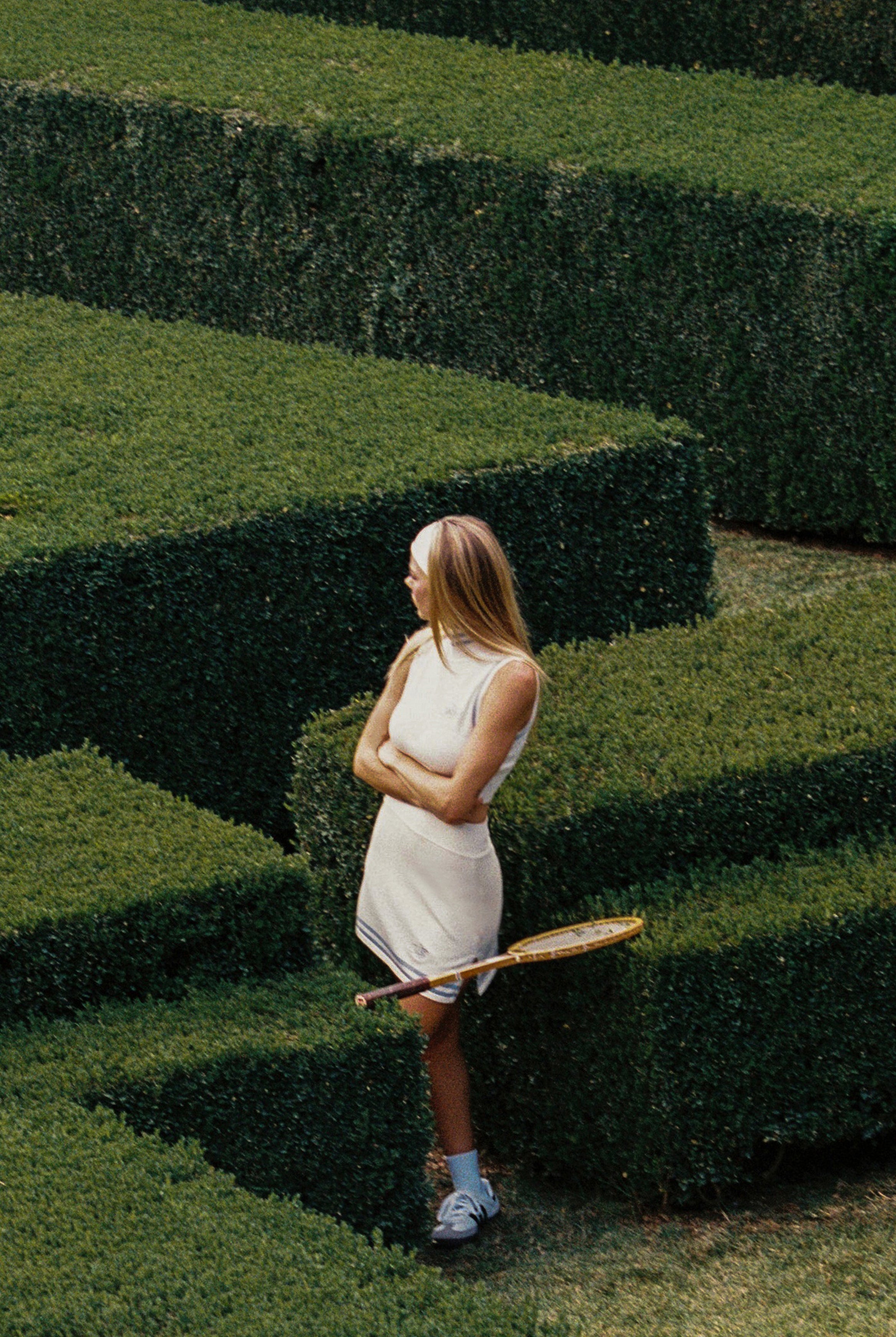 Cream WISKII Mirto Knit Mini Skirt shown on a model, featuring a fitted design and ribbed texture for a stylish look.