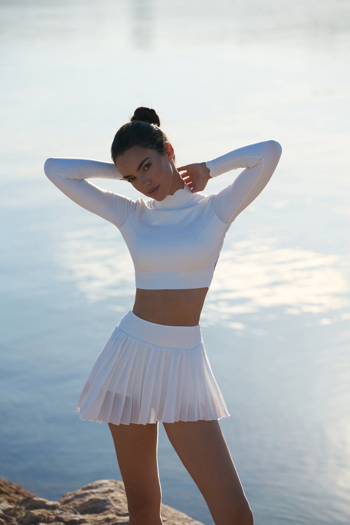 Ivory WISKII Lite Pleated Skirt with soft fabric and elegant pleats, styled on a model for a chic, casual look.