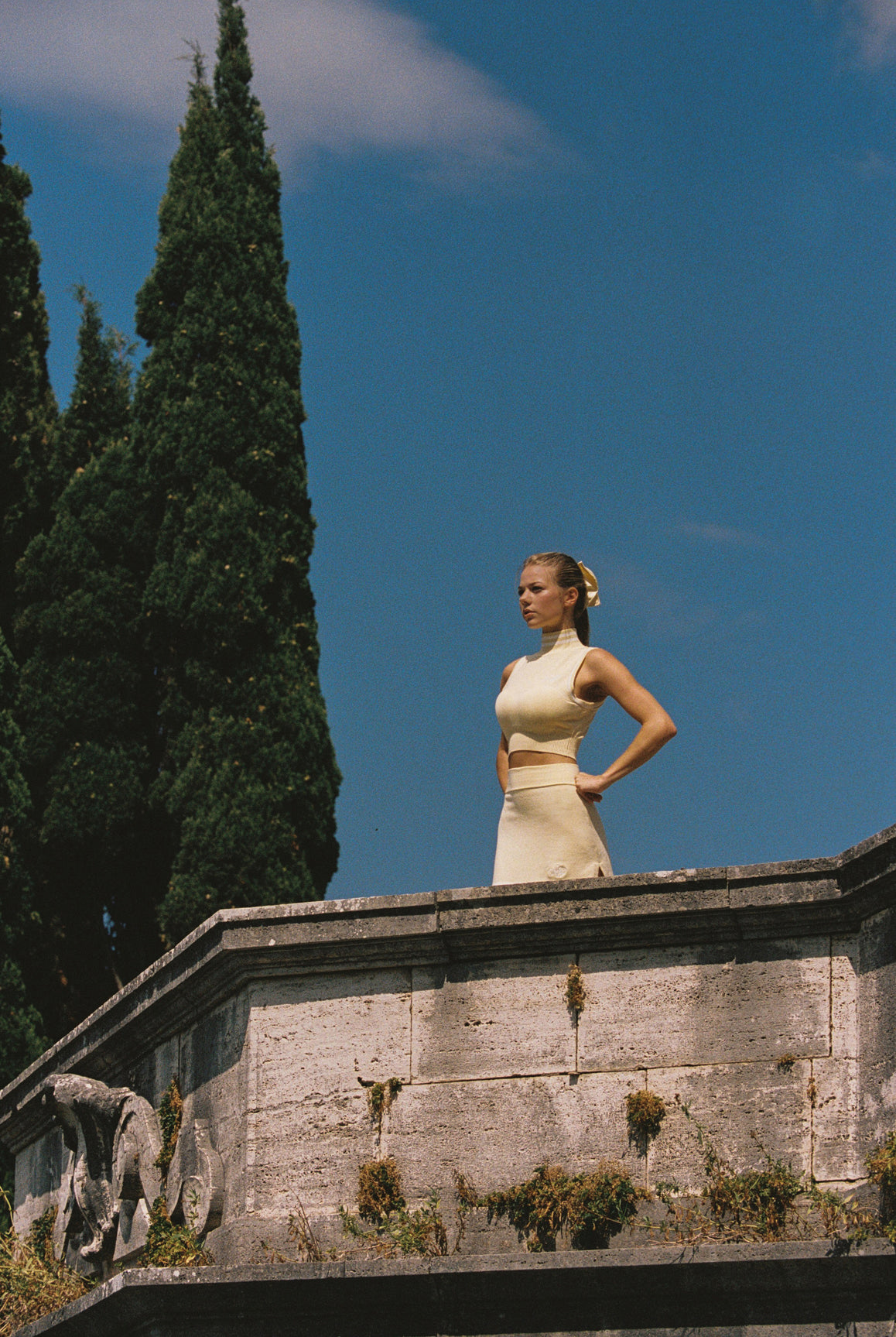 WISKII Mirto Knit Mini Skirt in lemon chiffon, featuring a fitted silhouette and textured knit fabric for a stylish look.