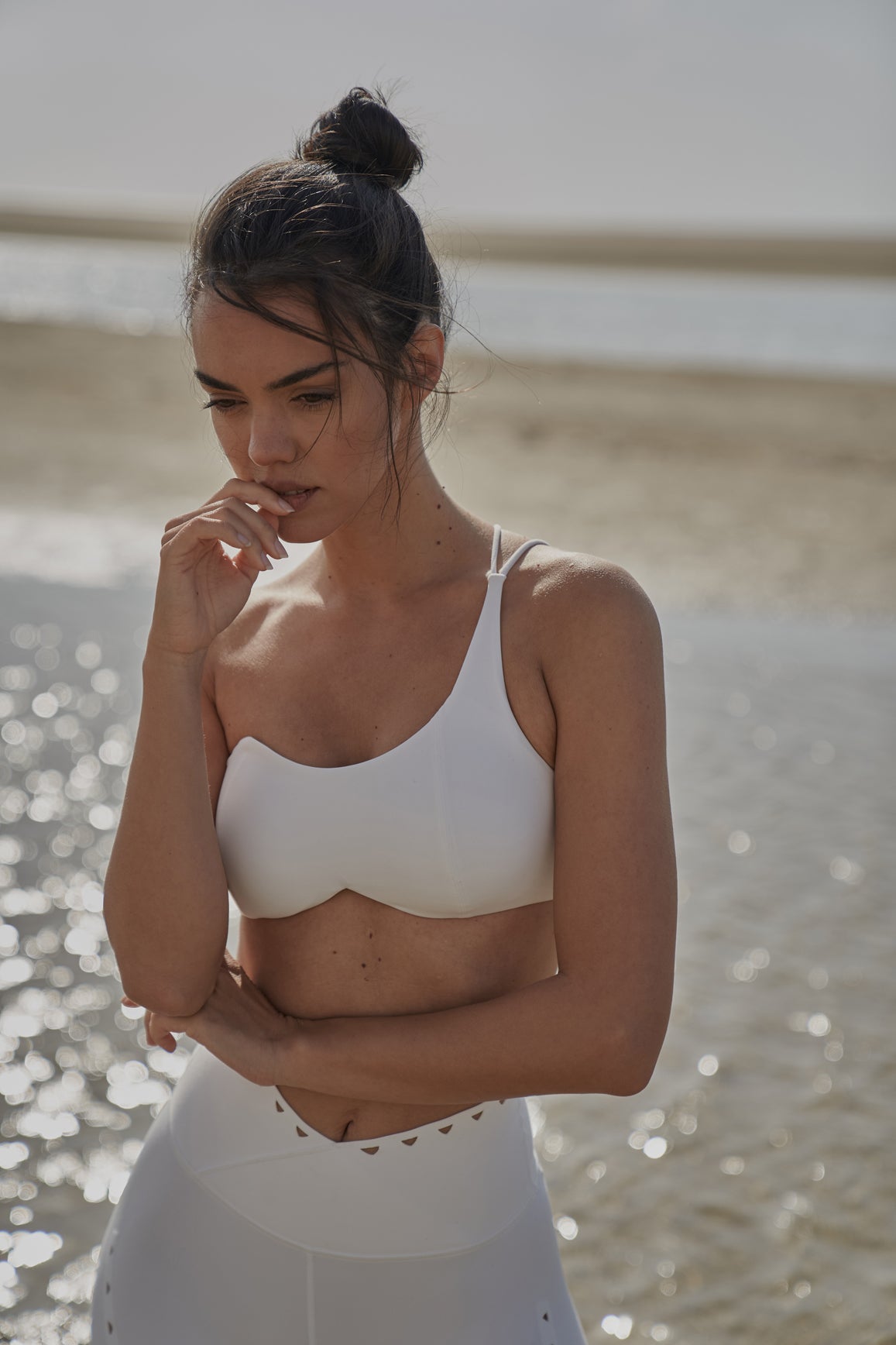 Black WISKII one-shoulder contour sports bra with supportive design and sleek fit, ideal for active wear or workout sessions.