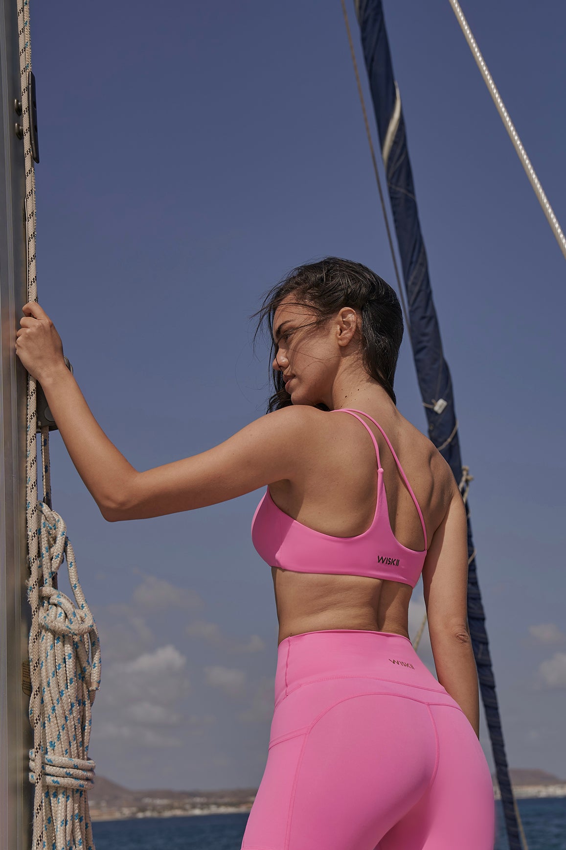 Black WISKII one shoulder contour sports bra with sleek design and supportive fit, ideal for active wear.