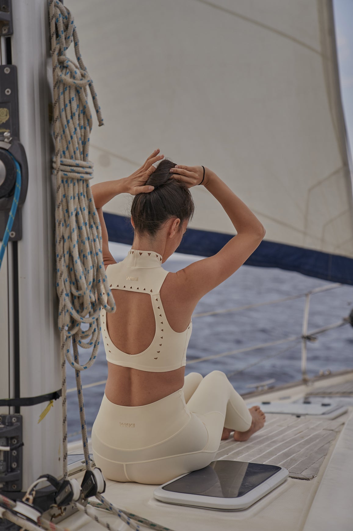 High neck laser cut leisure sports bra in ivory by WISKII, featuring a stylish design and comfortable fit.