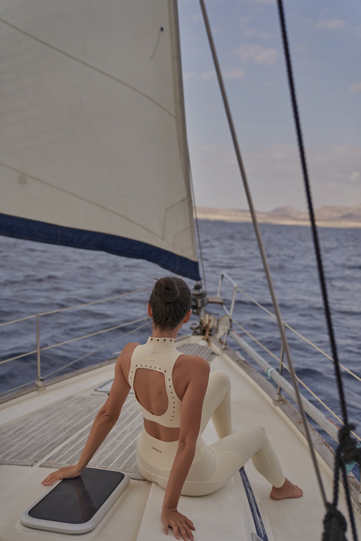 WISKII high neck laser cut leisure bra in ivory, featuring a stylish design for comfortable sportswear.