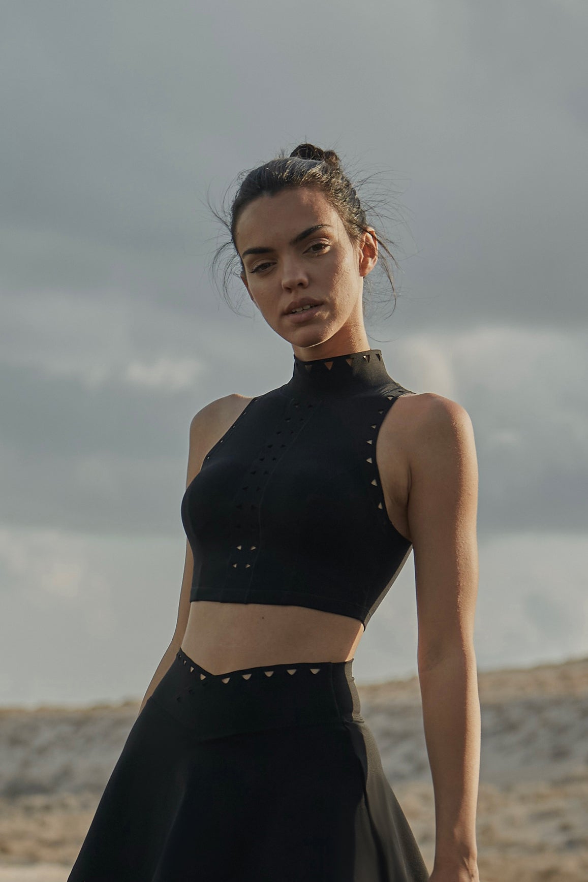 WISKII high neck laser cut leisure sports bra in ivory, featuring intricate cutouts and a stylish, comfortable design.