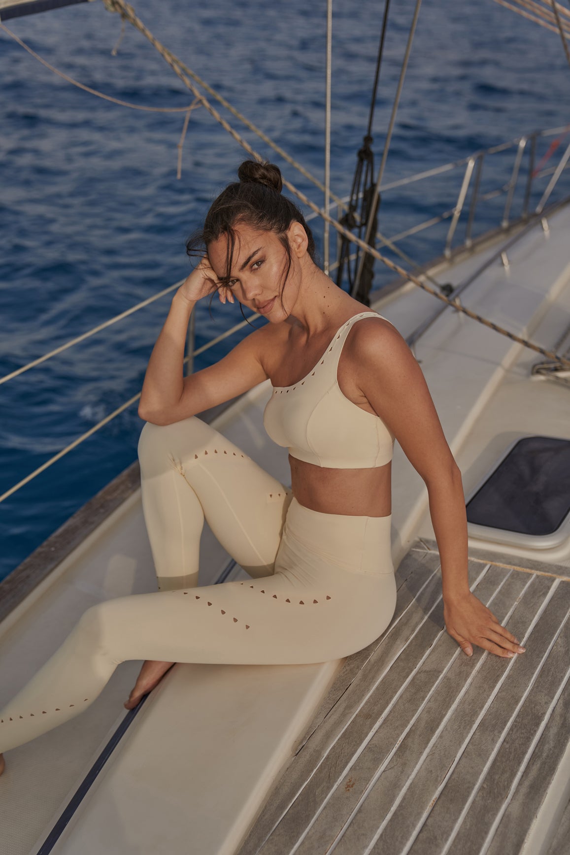 Ivory one-shoulder laser cut sports bra by WISKII, featuring sleek design and breathable fabric for active wear.